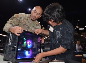 Twenty cyber Airmen, from the 16th Air Force and subordinate units, joined local tech partners to help nearly 100 students build their own computers April 29, 2023, at Tech Port Arena, in San Antonio, Texas. For many of the students it was their first liquid-cooled PC build