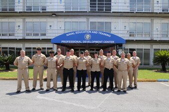 230510-N-YR423-6227 PENSACOLA, Fla. – Naval Education and Training Command (NETC) Force Master Chief Rick Mengel, left, poses for a photograph with the NETC domain fiscal year 2022 Sailor of the Year (SOY) candidates and their command master chiefs during a tour of the Naval Education and Professional Development Center (NETPDC) facilities onboard Saufley Field in Pensacola, Florida, May 10, 2023. The candidates and their master chiefs learned about NETPDC’s mission of administering voluntary education programs, administering the Navy’s enlisted advancement program, and providing resources management services to assigned activities.  (U.S. Navy photo by Cheryl Dengler)