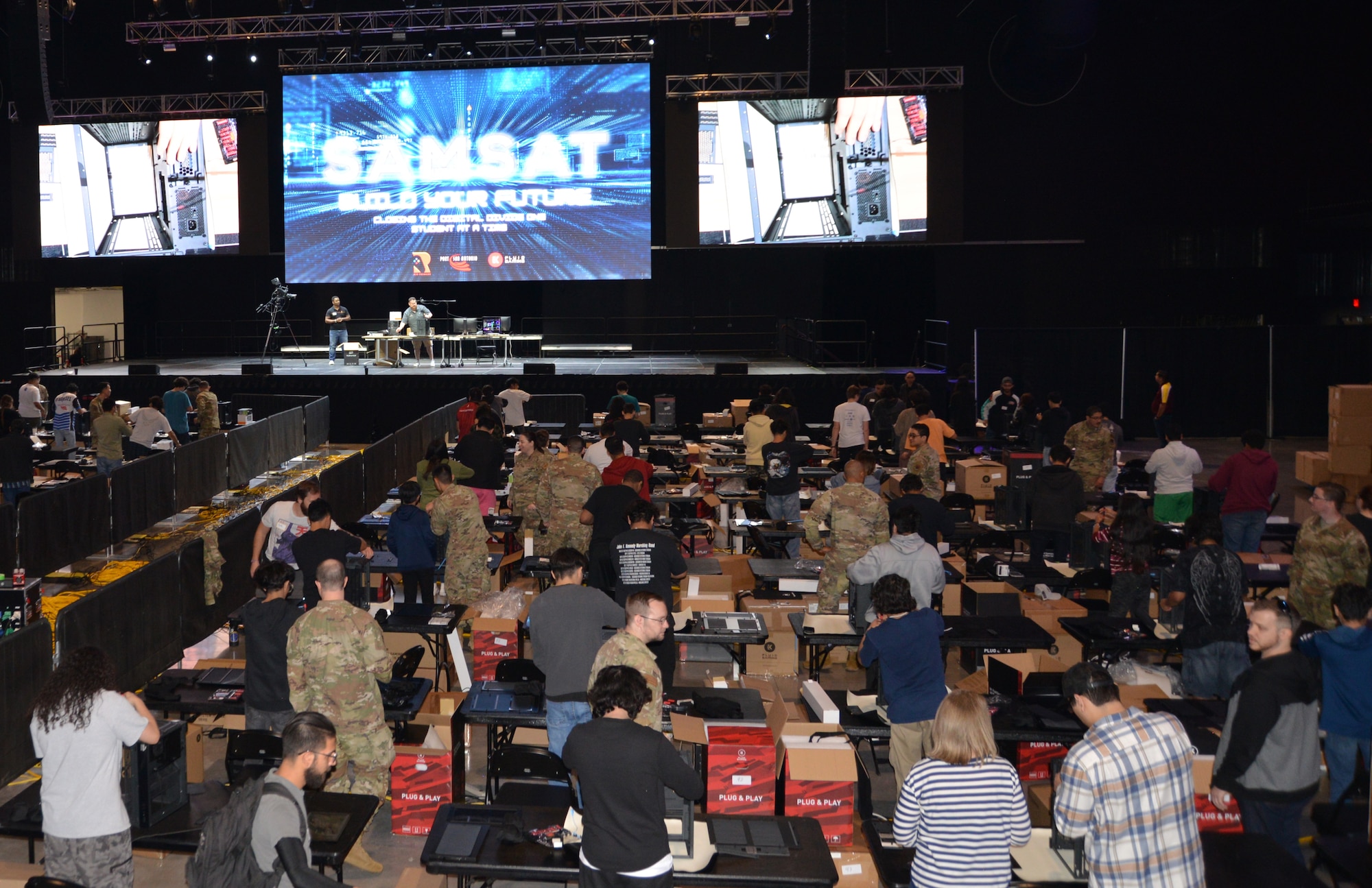 Twenty cyber Airmen, from the 16th Air Force and subordinate units, joined local tech partners to help nearly 100 students build their own computers April 29, 2023, at Tech Port Arena, in San Antonio, Texas. For many of the students it was their first liquid-cooled PC build