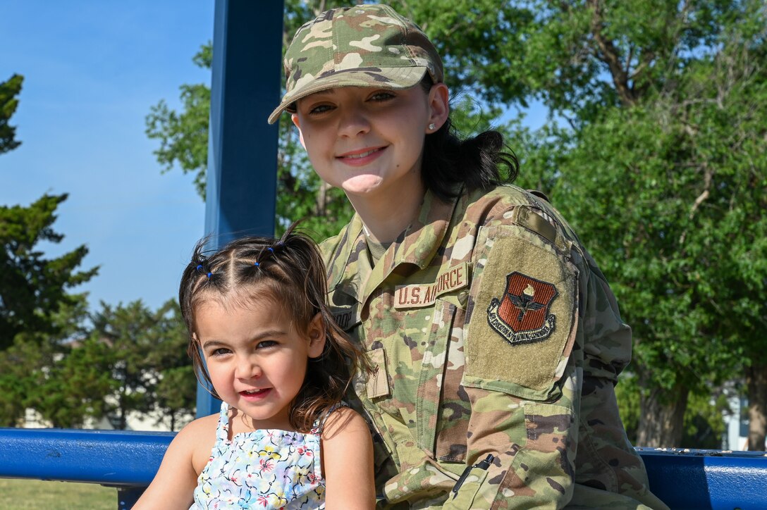 U.S. Air Force Airman 1st Class Jaiden Roop, 97th Logistics Readiness Squadron material management airman, poses for a photo with her daughter, Emberly, at Altus Air Force Base, Oklahoma, May 9, 2023. There are 240,643 children among all active duty Air Force service members. (U.S. Air Force photo by Senior Airman Kayla Christenson)