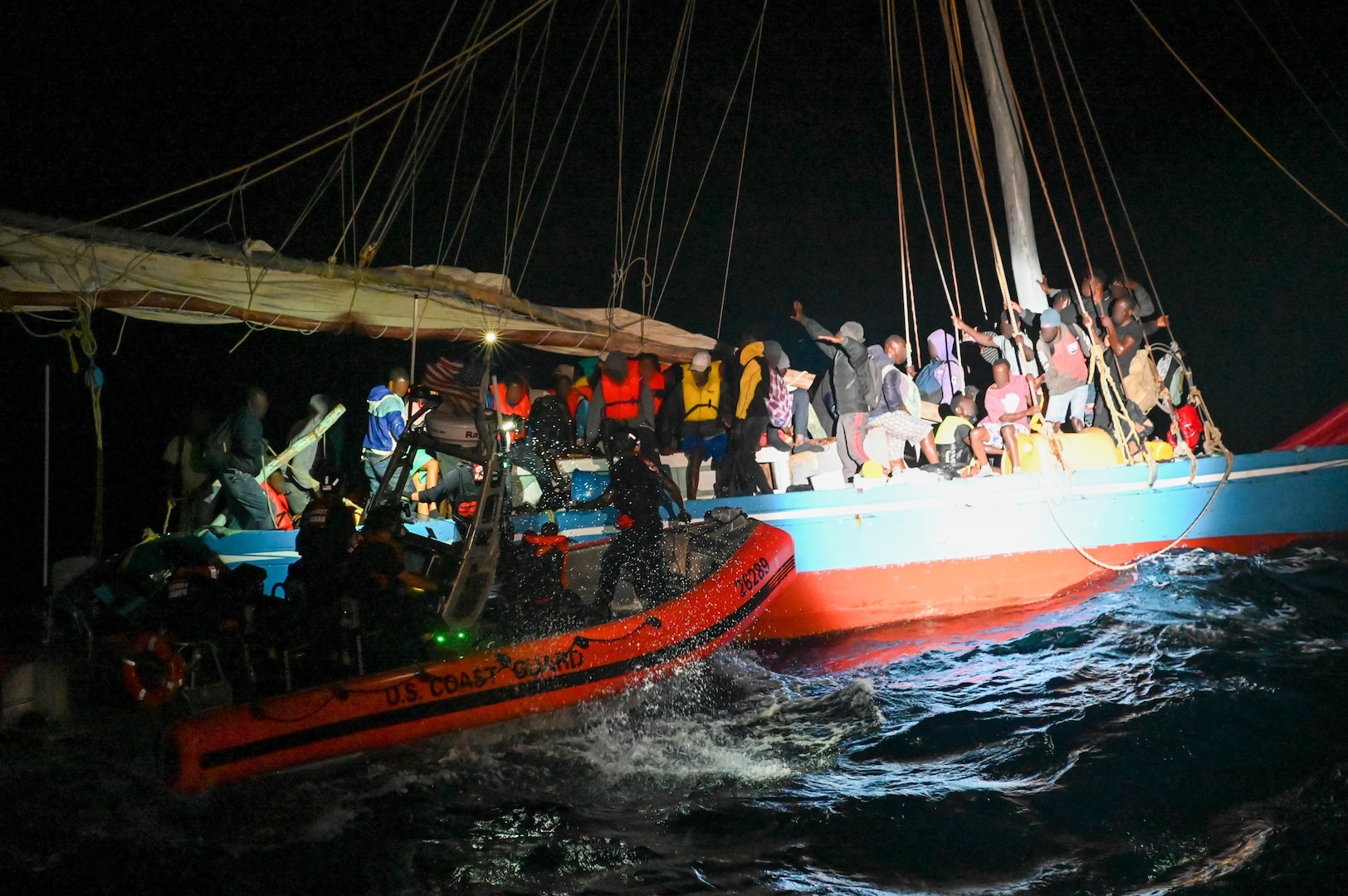 The crew of the USCGC Campbell (WMEC 909) interdicts an overloaded Haitian sail freighter carrying 219 people, April 7, 2023, in the South Florida Straits. While underway in the Seventh Coast Guard District’s area of responsibility, Campbell’s crew conducted maritime safety and security missions while working to detect, deter and intercept unsafe and illegal maritime migration ventures bound for the United States. (U.S. Coast Guard photo by Petty Officer 3rd Class Riley Perkofski)