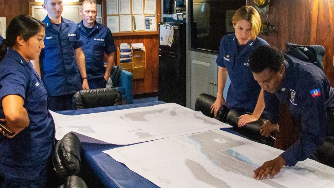 USCGC Campbell’s (WMEC 909) crew discusses Campbell’s safe transit through the Canal de Tortue, Haiti, with a member of the Haitian Coast Guard, April 18, 2023. While underway in the Seventh Coast Guard District’s area of responsibility, Campbell’s crew conducted maritime safety and security missions while working to detect, deter and intercept unsafe and illegal maritime migration ventures bound for the United States. (U.S. Coast Guard photo by Petty Officer 2nd Class Stephen Touchton)