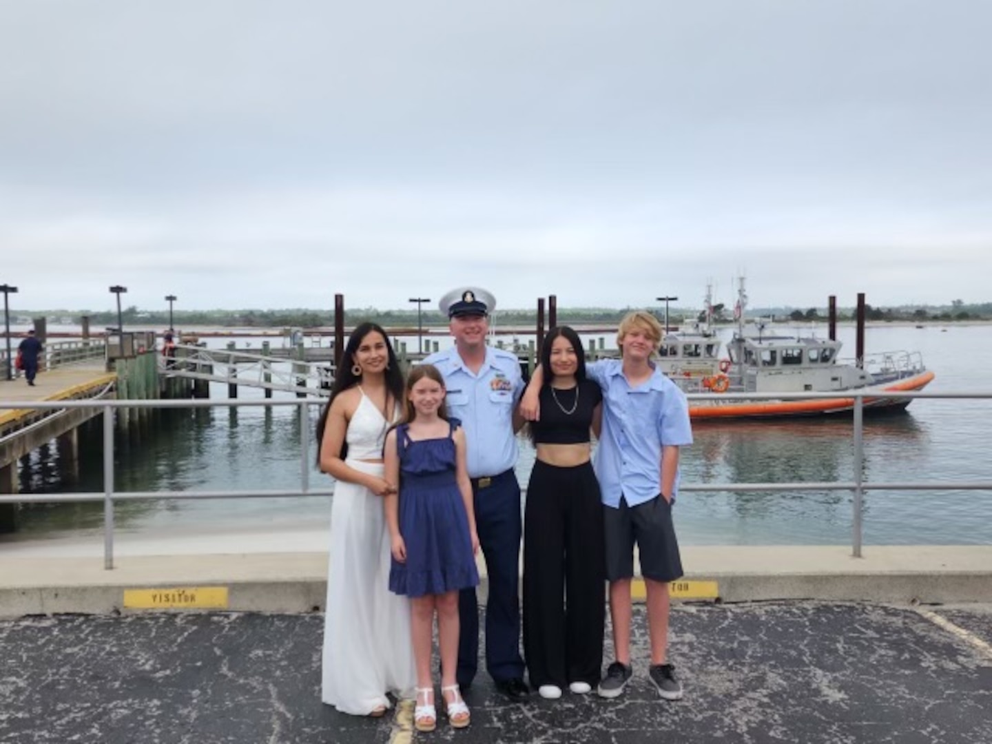 Carreno family poses in front of USCG asset