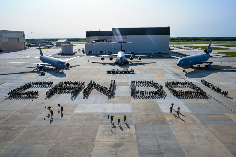 U.S. Air Force Airmen assigned to the 305th Air Mobility Wing pose for a flight line photo on 10 May, 2023 at Joint Base McGuire-Dix-Lakehurst, N.J. The 305th AMW extends America's global reach by generating, mobilizing and deploying KC-10 Extenders and C-17 Globemaster III’s to conduct strategic airlift and air refueling missions worldwide. In November 2021, the wing began transitioning to the new KC-46A Pegasus air refueling aircraft. Additionally, the Wing operates two of America's largest strategic aerial ports supporting the delivery of cargo and personnel to combatant commanders abroad.