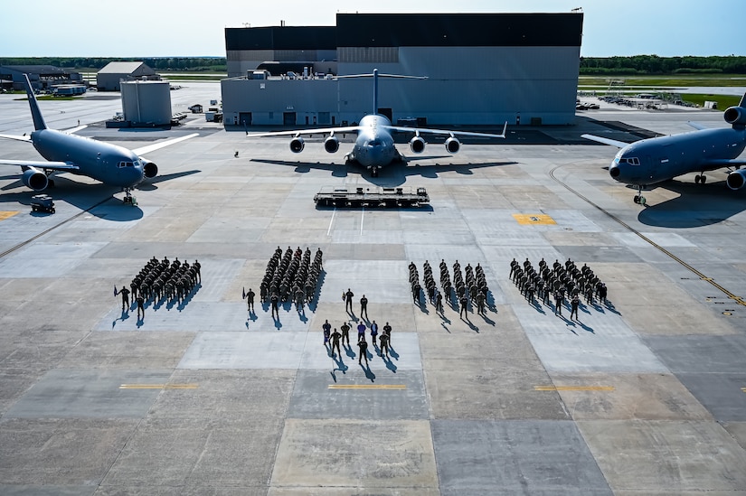 U.S. Air Force Airmen assigned to the 305th Air Mobility Wing pose for a flight line photo on 10 May, 2023 at Joint Base McGuire-Dix-Lakehurst, N.J. The 305th AMW extends America's global reach by generating, mobilizing and deploying KC-10 Extenders and C-17 Globemaster III’s to conduct strategic airlift and air refueling missions worldwide. In November 2021, the wing began transitioning to the new KC-46A Pegasus air refueling aircraft. Additionally, the Wing operates two of America's largest strategic aerial ports supporting the delivery of cargo and personnel to combatant commanders abroad.