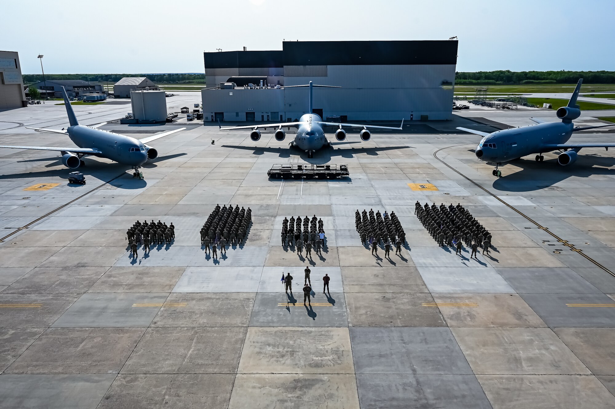 U.S. Air Force Airmen assigned to the 305th Air Mobility Wing pose for a flight line photo on 10 May, 2023 at Joint Base McGuire-Dix-Lakehurst, N.J. The 305th AMW extends America's global reach by generating, mobilizing and deploying KC-10 Extenders and C-17 Globemaster III’s to conduct strategic airlift and air refueling missions worldwide. In November 2021, the wing began transitioning to the new KC-46A Pegasus air refueling aircraft. Additionally, the Wing operates two of America's largest strategic aerial ports supporting the delivery of cargo and personnel to combatant commanders abroad.