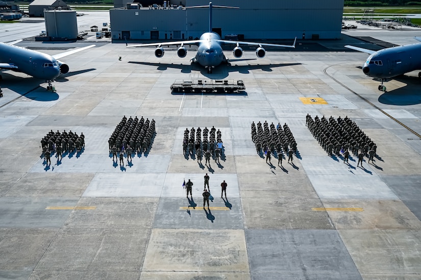 U.S. Air Force Airmen assigned to the 305th Air Mobility Wing pose for a flight line photo on 10 May, 2023 at Joint Base McGuire-Dix-Lakehurst, N.J. The 305th AMW extends America's global reach by generating, mobilizing and deploying KC-10 Extenders and C-17 Globemaster III’s to conduct strategic airlift and air refueling missions worldwide. In November 2021, the wing began transitioning to the new KC-46A Pegasus air refueling aircraft. Additionally, the Wing operates two of America's largest strategic aerial ports supporting the delivery of cargo and personnel to combatant commanders abroad.