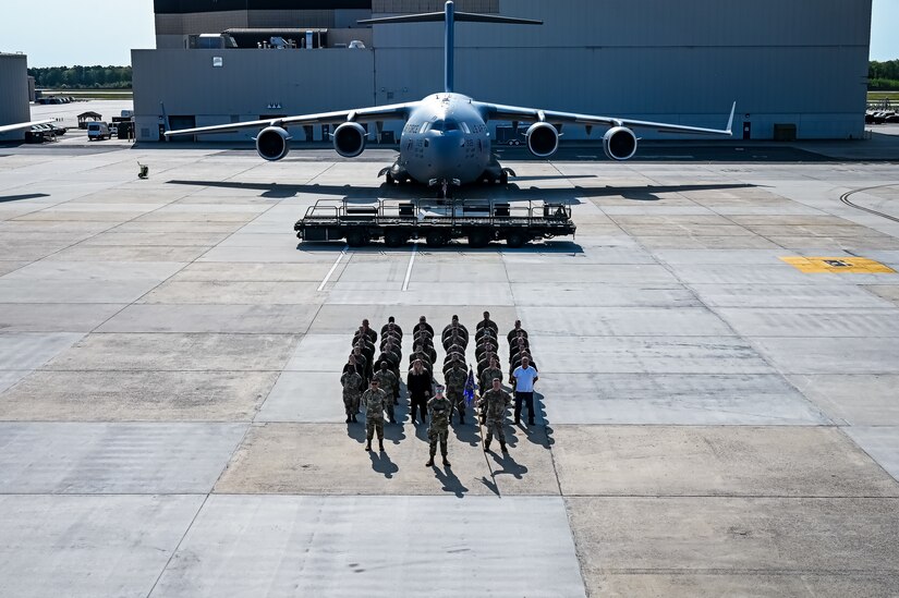 U.S. Air Force Airmen assigned to the 305th Air Mobility Wing pose for a flight line photo on 10 May, 2023 at Joint Base McGuire-Dix-Lakehurst, N.J. The 305th AMW extends America's global reach by generating, mobilizing and deploying KC-10 Extenders and C-17 Globemaster III’s to conduct strategic airlift and air refueling missions worldwide. In November 2021, the wing began transitioning to the new KC-46A Pegasus air refueling aircraft. Additionally, the Wing operates two of America's largest strategic aerial ports supporting the delivery of cargo and personnel to combatant commanders abroad.