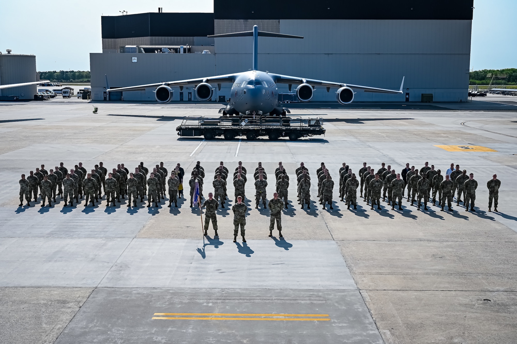 U.S. Air Force Airmen assigned to the 305th Air Mobility Wing pose for a flight line photo on 10 May, 2023 at Joint Base McGuire-Dix-Lakehurst, N.J. The 305th AMW extends America's global reach by generating, mobilizing and deploying KC-10 Extenders and C-17 Globemaster III’s to conduct strategic airlift and air refueling missions worldwide. In November 2021, the wing began transitioning to the new KC-46A Pegasus air refueling aircraft. Additionally, the Wing operates two of America's largest strategic aerial ports supporting the delivery of cargo and personnel to combatant commanders abroad.