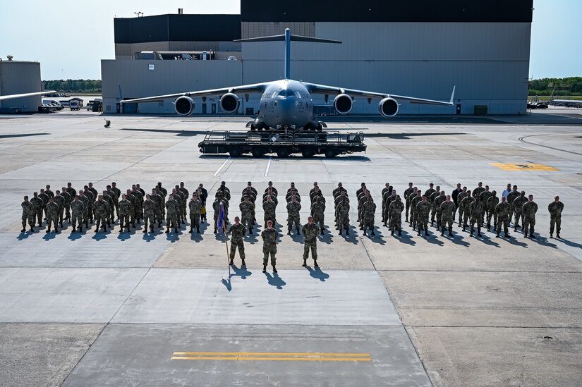 U.S. Air Force Airmen assigned to the 305th Air Mobility Wing pose for a flight line photo on 10 May, 2023 at Joint Base McGuire-Dix-Lakehurst, N.J. The 305th AMW extends America's global reach by generating, mobilizing and deploying KC-10 Extenders and C-17 Globemaster III’s to conduct strategic airlift and air refueling missions worldwide. In November 2021, the wing began transitioning to the new KC-46A Pegasus air refueling aircraft. Additionally, the Wing operates two of America's largest strategic aerial ports supporting the delivery of cargo and personnel to combatant commanders abroad.