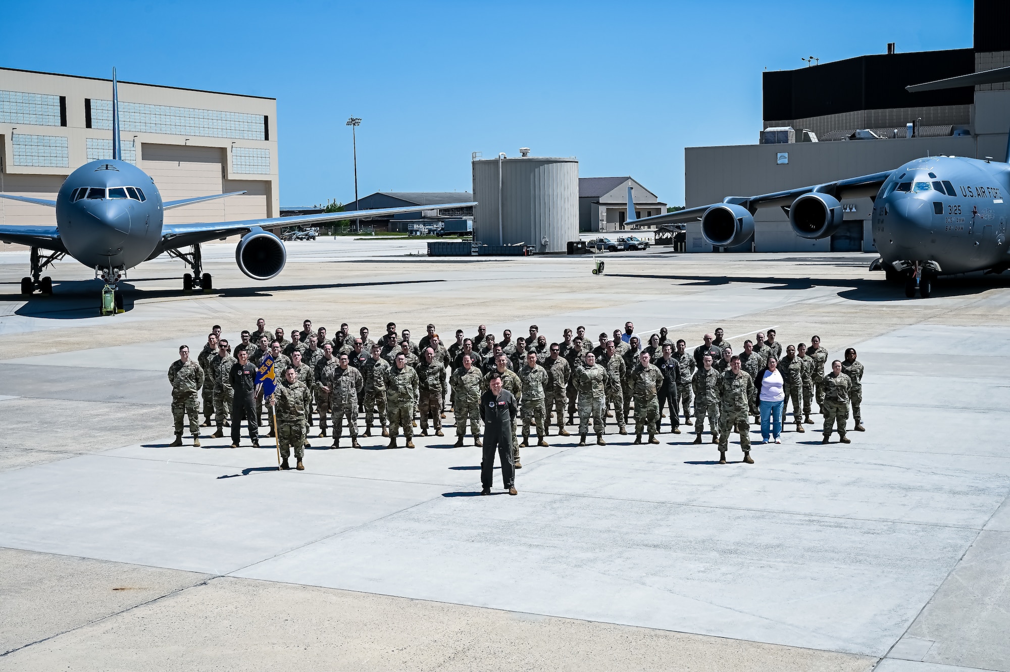 U.S. Air Force Airmen assigned to the 305th Air Mobility Wing pose for a flight line photo on 10 May, 2023 at Joint Base McGuire-Dix-Lakehurst, N.J. The 305th AMW extends America's global reach by generating, mobilizing and deploying KC-10 Extenders and C-17 Globemaster III’s to conduct strategic airlift and air refueling missions worldwide. In November 2021, the wing began transitioning to the new KC-46A Pegasus air refueling aircraft. Additionally, the Wing operates two of America's largest strategic aerial ports supporting the delivery of cargo and personnel to combatant commanders abroad.