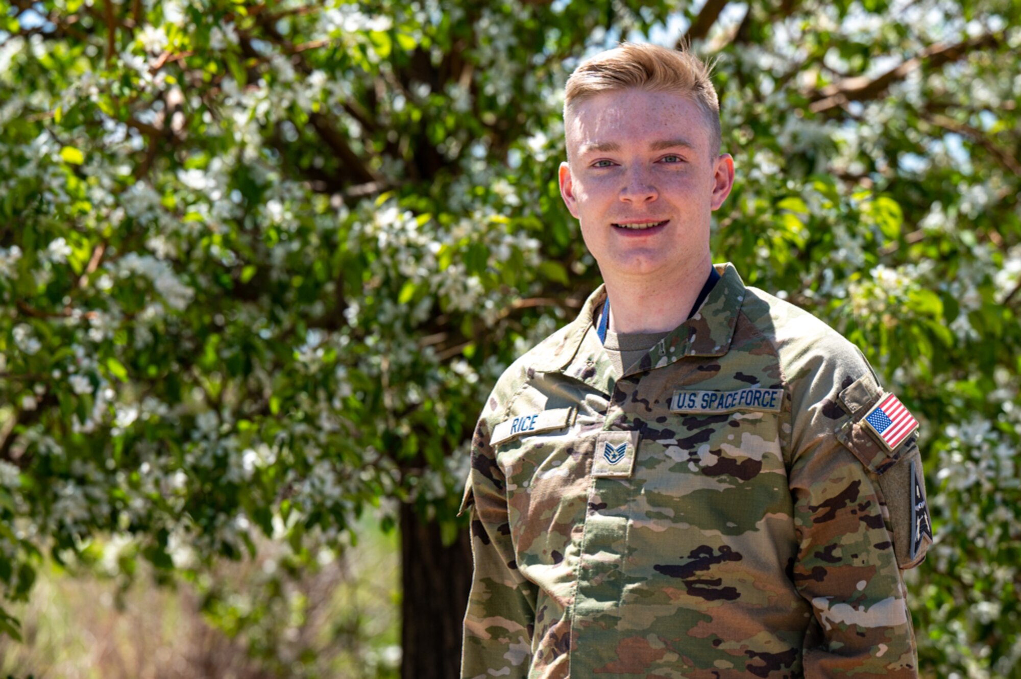 Space Force Guardian Poses for picture in front of blurred out tree