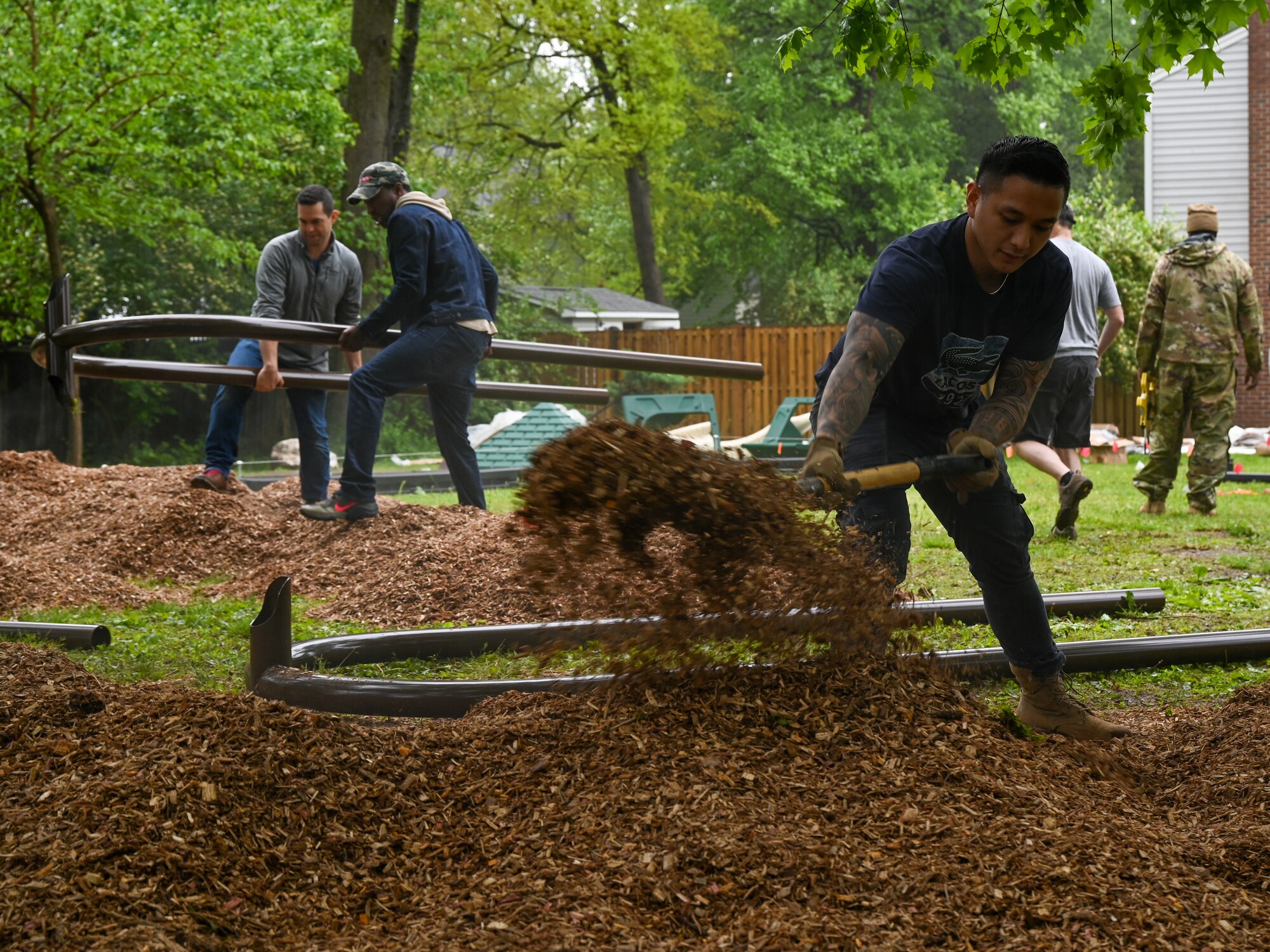 Members of the 113th Civil Engineer Squadron, District of Columbia Air National Guard, spread mulch and arrange segments of playground equipment as they participate in a volunteer project to complete the Master Sgt. Scott Walters Memorial Playground in Vienna, Virginia, April 29th, 2023. Walters, a well-loved member of the unit and community organizer, asked for the playground to be constructed as one of his final wishes. (U.S. Air Force photo by Tech. Sgt. Andrew Enriquez)