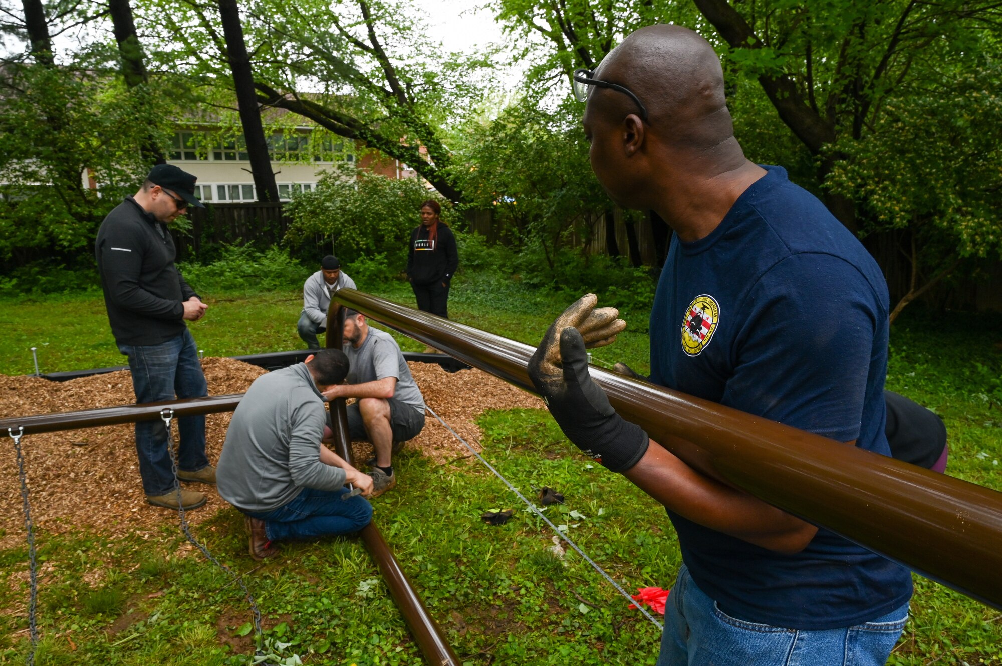 Members of the 113th Civil Engineer Squadron, District of Columbia Air National Guard, assemble segments of playground equipment as they participate in a volunteer project to complete the Master Sgt. Scott Walters Memorial Playground in Vienna, Virginia, April 29th, 2023. Walters, a well-loved member of the unit and community organizer, asked for the playground to be constructed as one of his final wishes. (U.S. Air Force photo by Tech. Sgt. Andrew Enriquez)