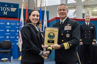 Rear Adm. Pete Garvin, right, commander, Naval Education and Training Command (NETC), awards a plaque to Aviation Structural Mechanic First Class Ashleylaura K. Sembrano, assigned to Recruit Training Command Great Lakes, Illinois, one of NETC’s fiscal year 2022 Sailor of the Year (SOY) finalists, during NETC’s SOY announcement and award ceremony at the National Naval Aviation Museum in Pensacola, Florida, May 11, 2023. NETC's mission is to recruit, train and deliver those who serve our nation, taking them from street-to-fleet by forging civilians into highly skilled, operational and combat ready warfighters. (United States Navy photo by Mass Communication Specialist 2nd Class Zachary Melvin)
