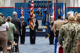 Rear Adm. Pete Garvin, center, commander, Naval Education and Training Command (NETC), salutes during the national anthem during NETC’s fiscal year 2022 Sailor of the Year (SOY) announcement and award ceremony at the National Naval Aviation Museum in Pensacola, Florida, May 11, 2023. NETC's mission is to recruit, train and deliver those who serve our nation, taking them from street-to-fleet by forging civilians into highly skilled, operational and combat ready warfighters. (United States Navy photo by Mass Communication Specialist 2nd Class Zachary Melvin)