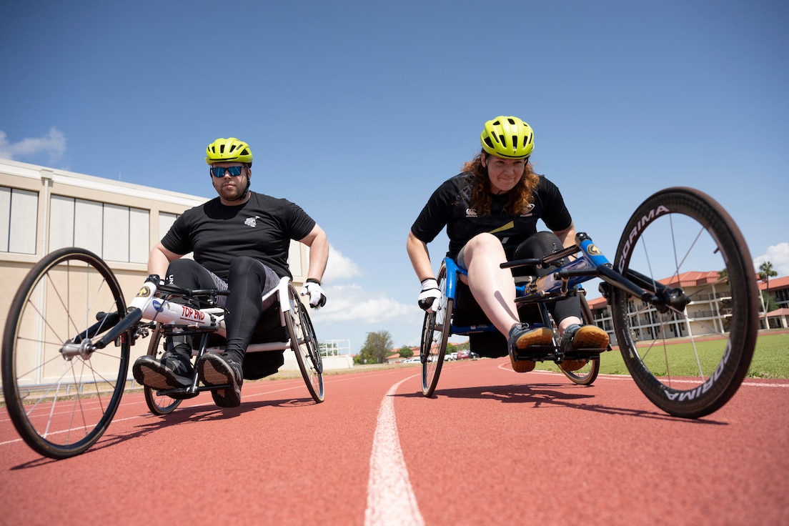 RSMs practice wheelchair racing on the track.