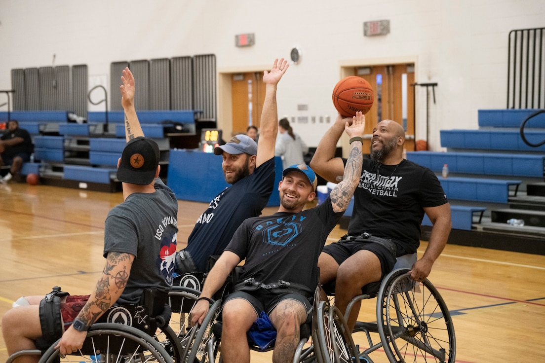 RSMs smile during wheelchair basketball practice.