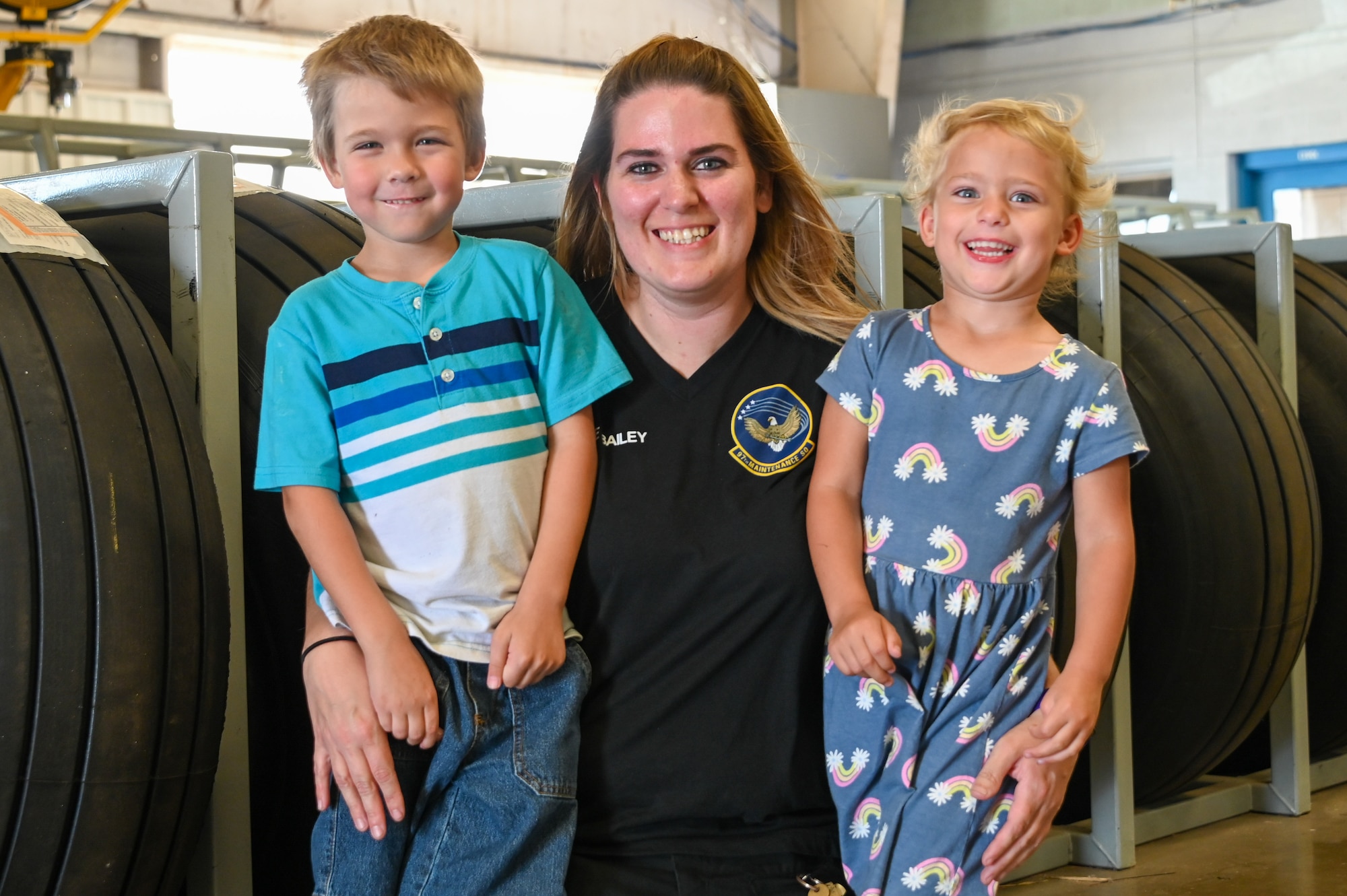 Julie Waldroop, 97th Maintenance Squadron aircraft technician, poses for a photo with her children, Trey and Allie, at Altus Air Force Base, Oklahoma, May 10, 2023. The Department of Defense employs more than 700,000 civilians. (U.S. Air Force photo by Senior Airman Kayla Christenson)