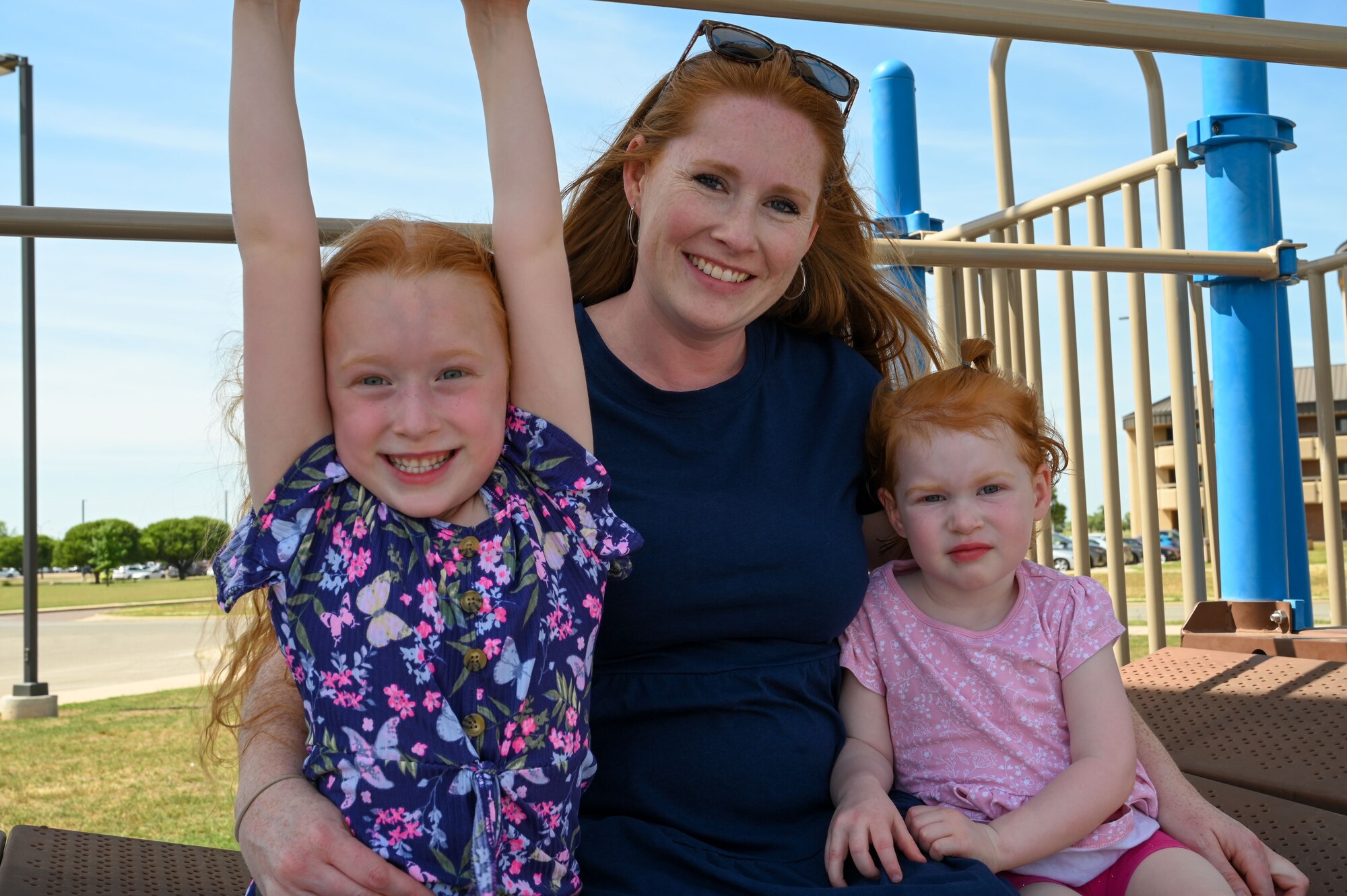 Ashley Adams, wife of Master Sgt. Kyle Adams, 97th Training Squadron first sergeant, poses for a photo with her daughters, Aubrey and Laurel, at Altus Air Force Base, Oklahoma, May 9, 2023. There are more active duty family members than active duty members in the Department of Defense. (U.S. Air Force photo by Senior Airman Kayla Christenson)