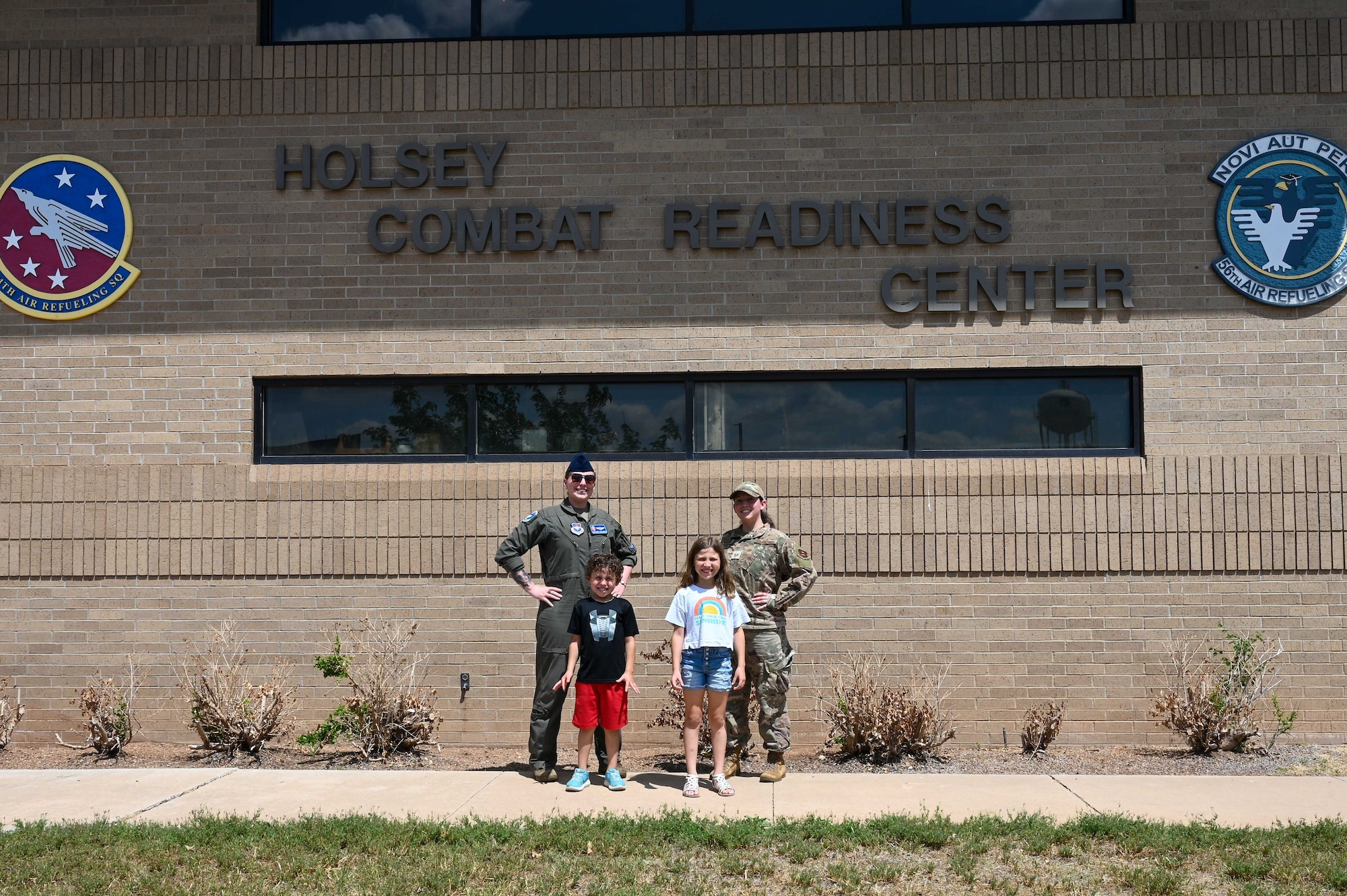 U.S. Air Force Tech. Sgt. Carrie McLaughlin, 56th Air Refueling Squadron (ARS) boom operator instructor, and Tech. Sgt. Almquist, 54th ARS squadron aviation resource manager non-commissioned officer in charge, pose with Almquist’s children, Bryanna and Deaglan, at Altus Air Force Base, Oklahoma, May 10, 2023. McLaughlin is a step-mom, or “bonus mom,” to Bryanna and Deaglan. (U.S. Air Force photo by Airman 1st Class Kari Degraffenreed)