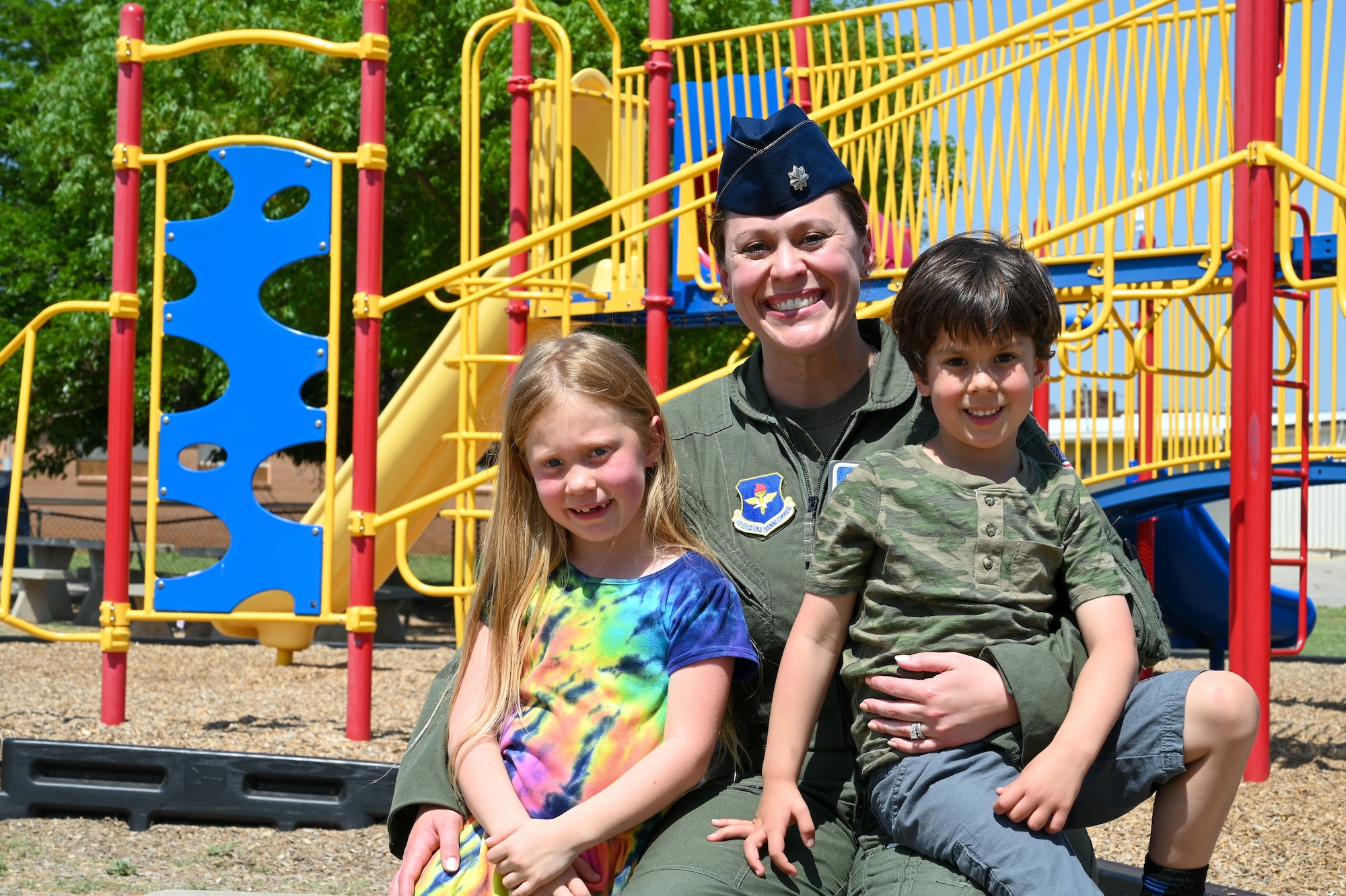 U.S. Air Force Lt. Col. Elizabeth Shaw, 97th Training Squadron operations officer, poses for a photo with her kids, Lillian and John, at Altus Air Force Base, Oklahoma, May 8, 2023. There are 1,025 female pilots in the U.S. Air Force. (U.S. Air Force photo by Senior Airman Kayla Christenson)