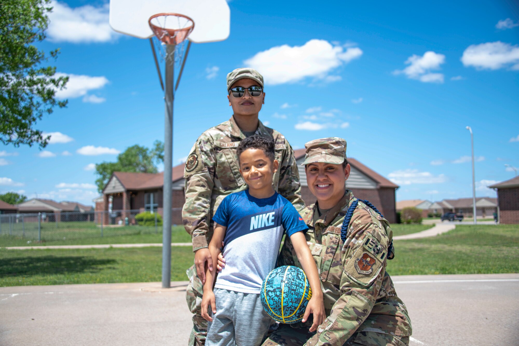 Left, Staff Sgt. Lucille Galang, 97th Communications Squadron base equipment custodian, and Tech Sgt. Kylee Galang, 97th Training Squadron military training leader, pose for a photo with their son, May 4, 2021, at Altus Air Force Base, Oklahoma. Their motto as parents is to “be the mother you want your child to remember,” by showing their son everyday how much they love him. Their advice to other moms is to take care of themselves so their children can have them at their best. (U.S. Air Force photo by Staff Sgt. Cody Dowell)