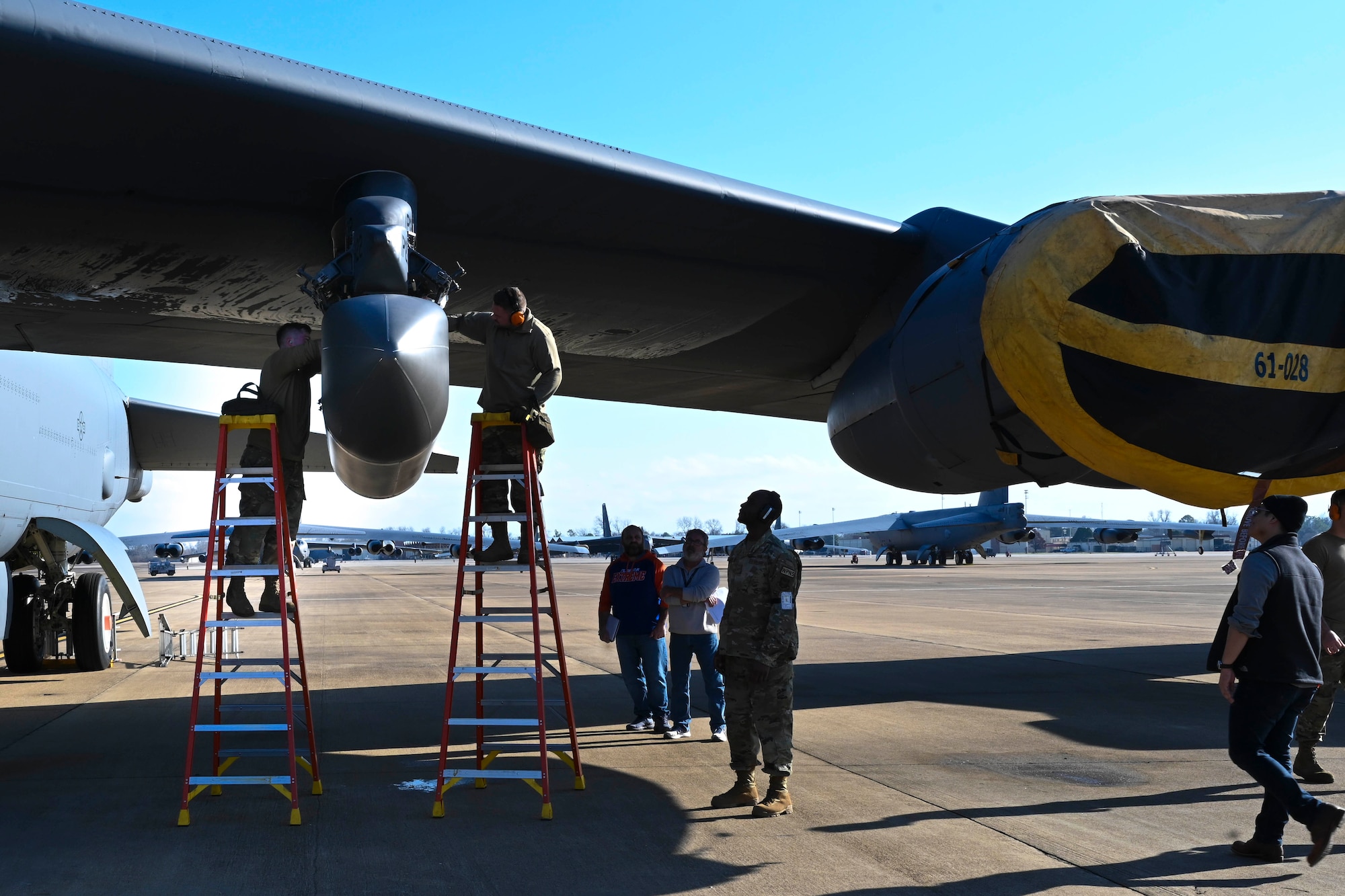 An Airman installs an AgilePod onto a B-52