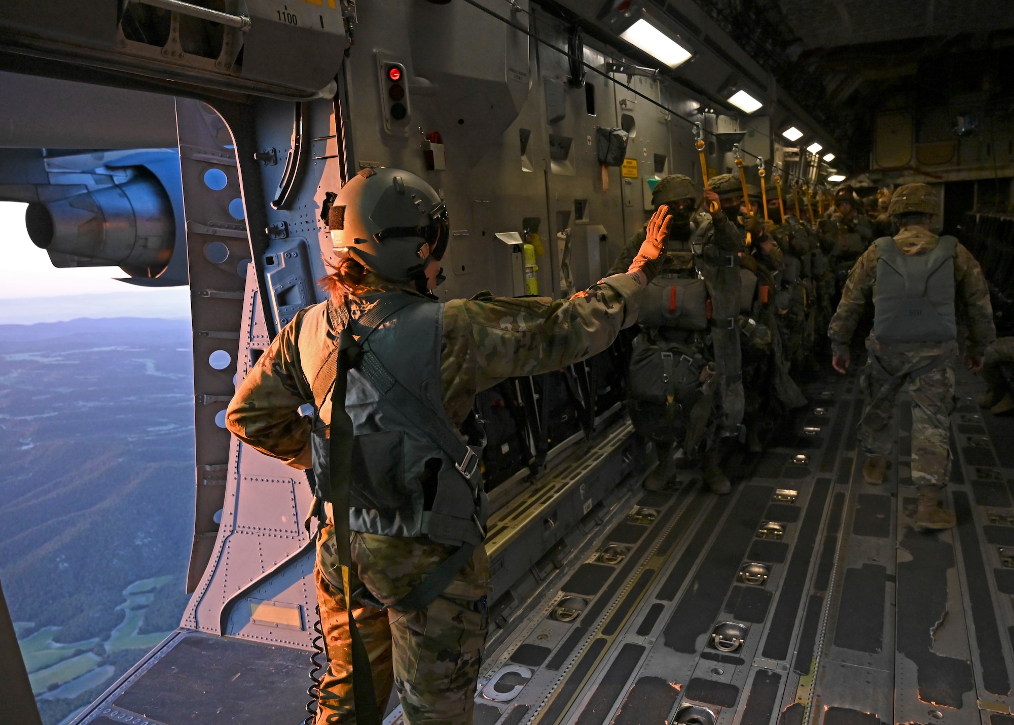U.S Air Force Senior Airman Abby Beachnau, loadmaster with the 7th Expeditionary Airlift Squadron, gives a five-minute warning to Spanish paratroopers with the Grupo De Artilleria during DEFENDER 23 over Spain, May 10, 2023. DEFENDER 23 is a U.S. Army Europe and Africa-led exercise, supported by U.S. Air Forces in Europe – Air Forces Africa, focused on the strategic deployment of continental United States-based forces and interoperability with Allies and partners. Taking place from April 22 to June 23, DEFENDER 23 demonstrates the U.S. Air Force’s ability to aggregate U.S.-based combat power quickly in Europe; increase lethality of the NATO Alliance through the U.S. Air Force’s Agile Combat Employment; build unit readiness in a complex joint, multi-national environment; and leverage host nation capabilities to increase USAFE-AFAFRICA’s operational reach. DEFENDER 23 includes more than 7,800 U.S. and 15,000 multi-national service members from various Allied and partner nations. (U.S Air Force photo by Senior Airman Callie Norton)