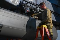 An Airman installs an AgilePod onto a B-52