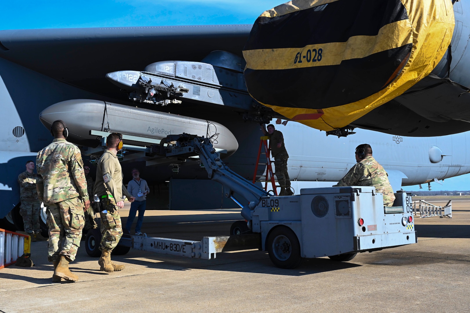An Airman installs an AgilePod onto a B-52