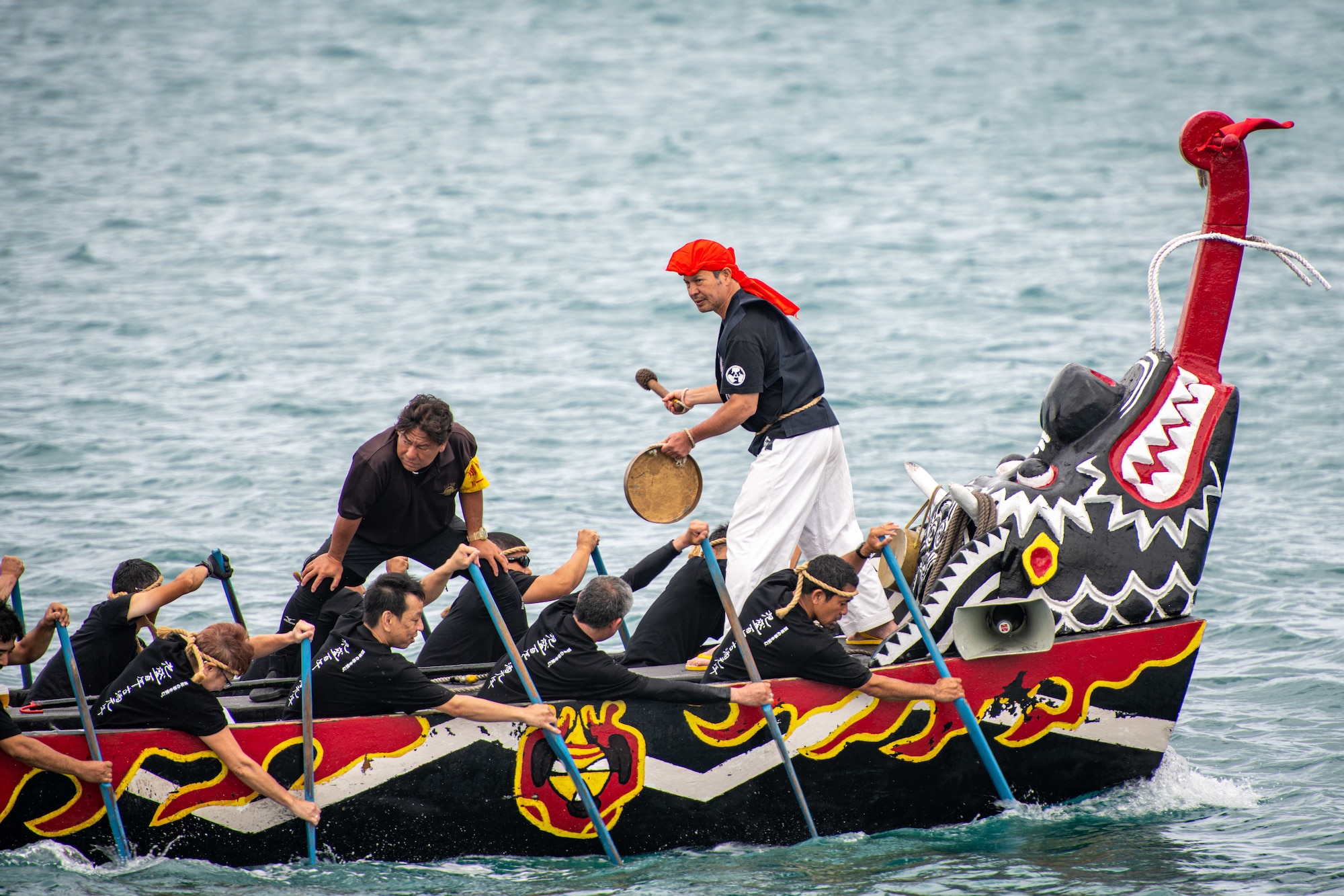 A Japanese team competes in the 2023 Naha Hari Dragon Boat Races in Naha City, Japan, May 5, 2023. Teams from Kadena Air Base joined other U.S. and Japanese boat teams in the first races held since the start of the COVID-19 pandemic. (U.S. Air Force photo by Lt. Col. Raymond Geoffroy)