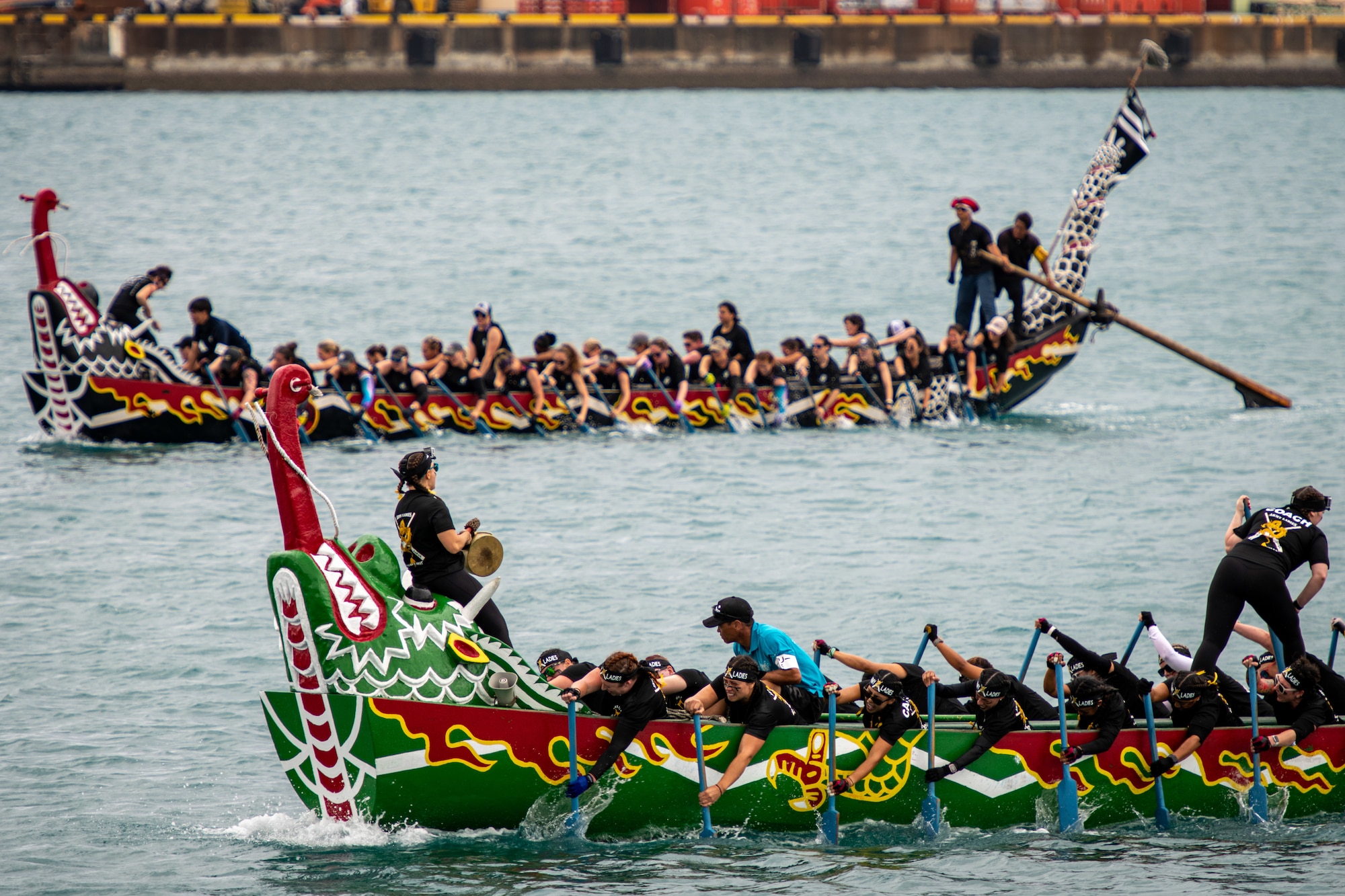 The U.S. Army Ladies and the Yasha Dragons boat race teams compete in the 2023 Naha Hari Dragon Boat Races in Naha City, Japan, May 5, 2023. The races marked the culmination of months of training by U.S. and Japanese teams from across Okinawa. (U.S. Air Force photo by Lt. Col. Raymond Geoffroy)