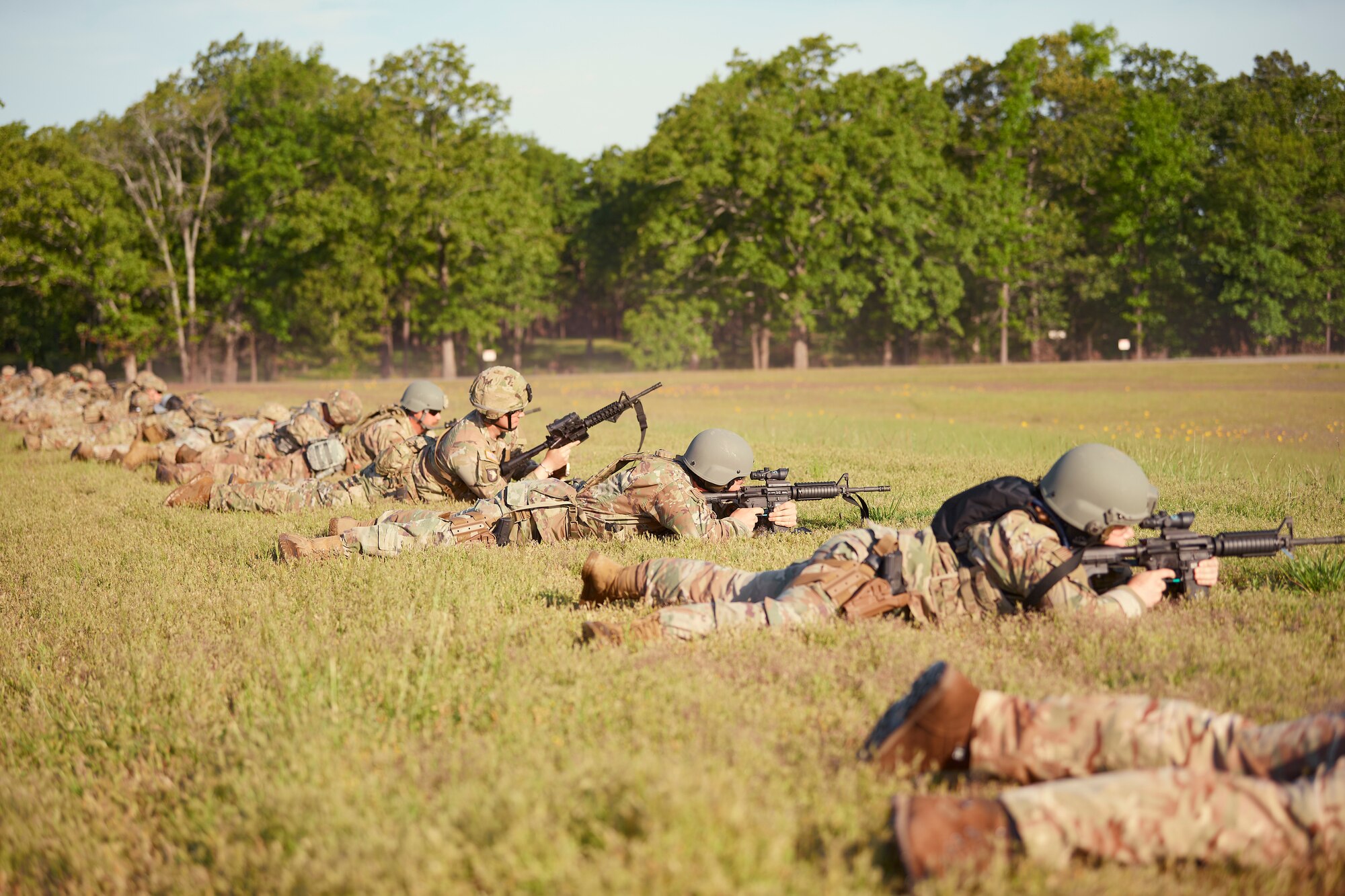 Photo of Competitors shooting from the prone position during a team event at the Winston P. Wilson competition at Camp Robinson, Arkansas, May 4, 2023.