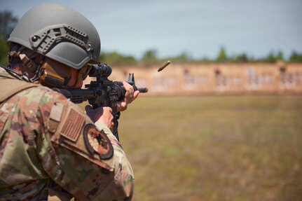 Photo of Master Sg.t Robert Marciniak from the Vermont Air National Guard's 158th Fighter Wing, shooting from the kneeling position during a team event at the Winston P. Wilson competition at Camp Robinson, Arkansas, May 3, 2023.