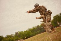 Photo of Competitors shooting their service pistols during the Winston P. Wilson competition at Camp Robinson, Arkansas, May 4, 2023.