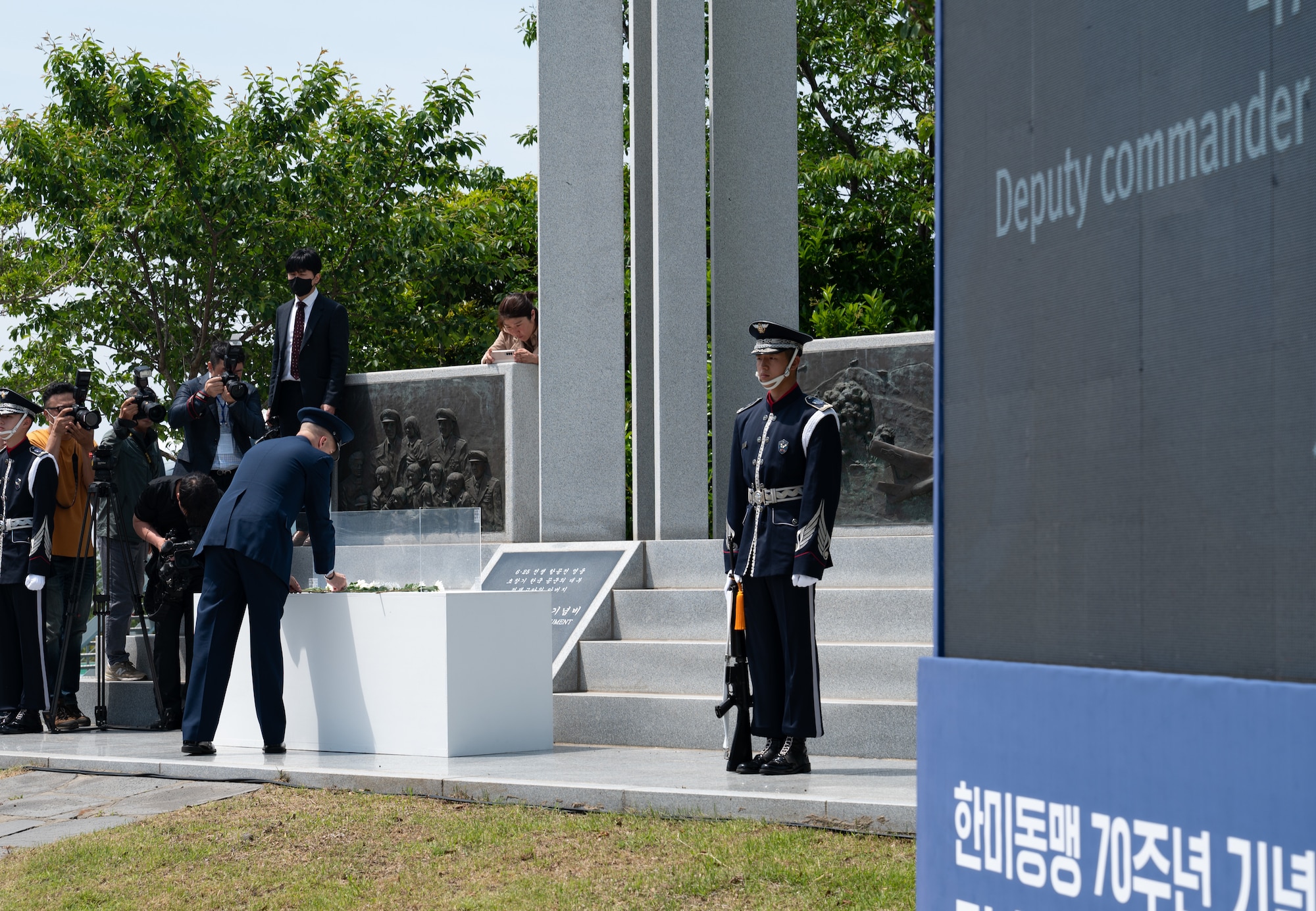U.S. Air Force Brig. Gen. Ryan P. Keeney, 7th Air Force deputy commander, places flowers on retired Col. Dean Hess’ monument during the Commemorative Dean Hess Ceremony at Jeju Aerospace Museum, Jeju, Republic of Korea, May 11, 2023.