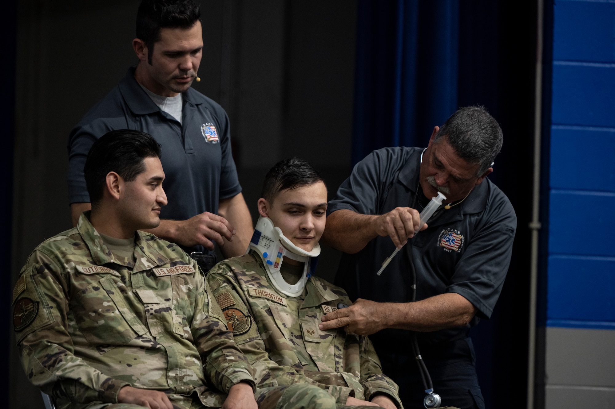 Street Smart presenters Austin Beamer, Tampa firefighter paramedic, back left, and Ronny Garcia, retired Tampa firefighter paramedic, perform simulated care on a patient