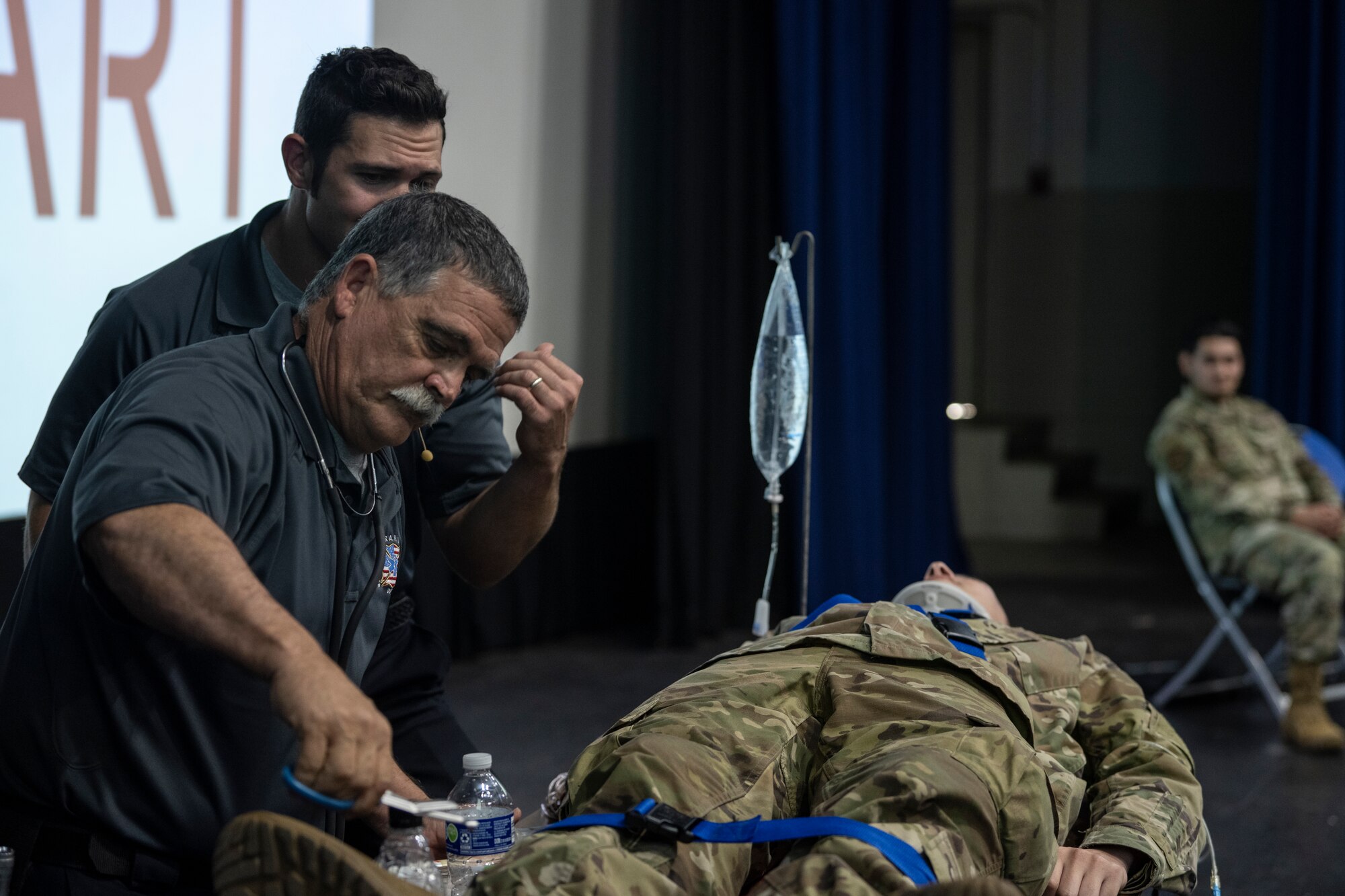 Street Smart presenters perform simulated care on a patient during a Street Smart presentation