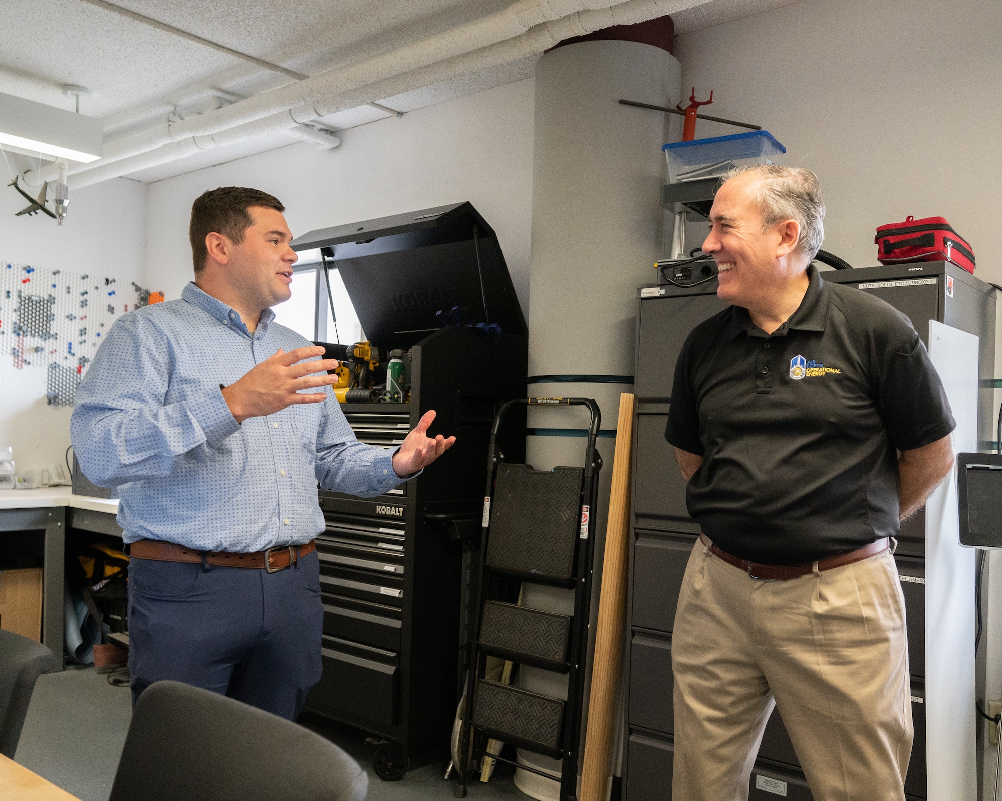 From the right, Roberto Guerrero, Deputy Assistant Secretary of the Air Force, speaks with Tech. Sgt. Christopher Saunders, Bedrock Innovation Lab intern, about innovative tools conceptualized in the lab at Dover Air Force Base, Delaware, May 7, 2023. Guerrero toured various units to help identify obstacles associated with everyday logistical tasks vital to combat mission accomplishment. (U.S. Air Force photo by Mauricio Campino)