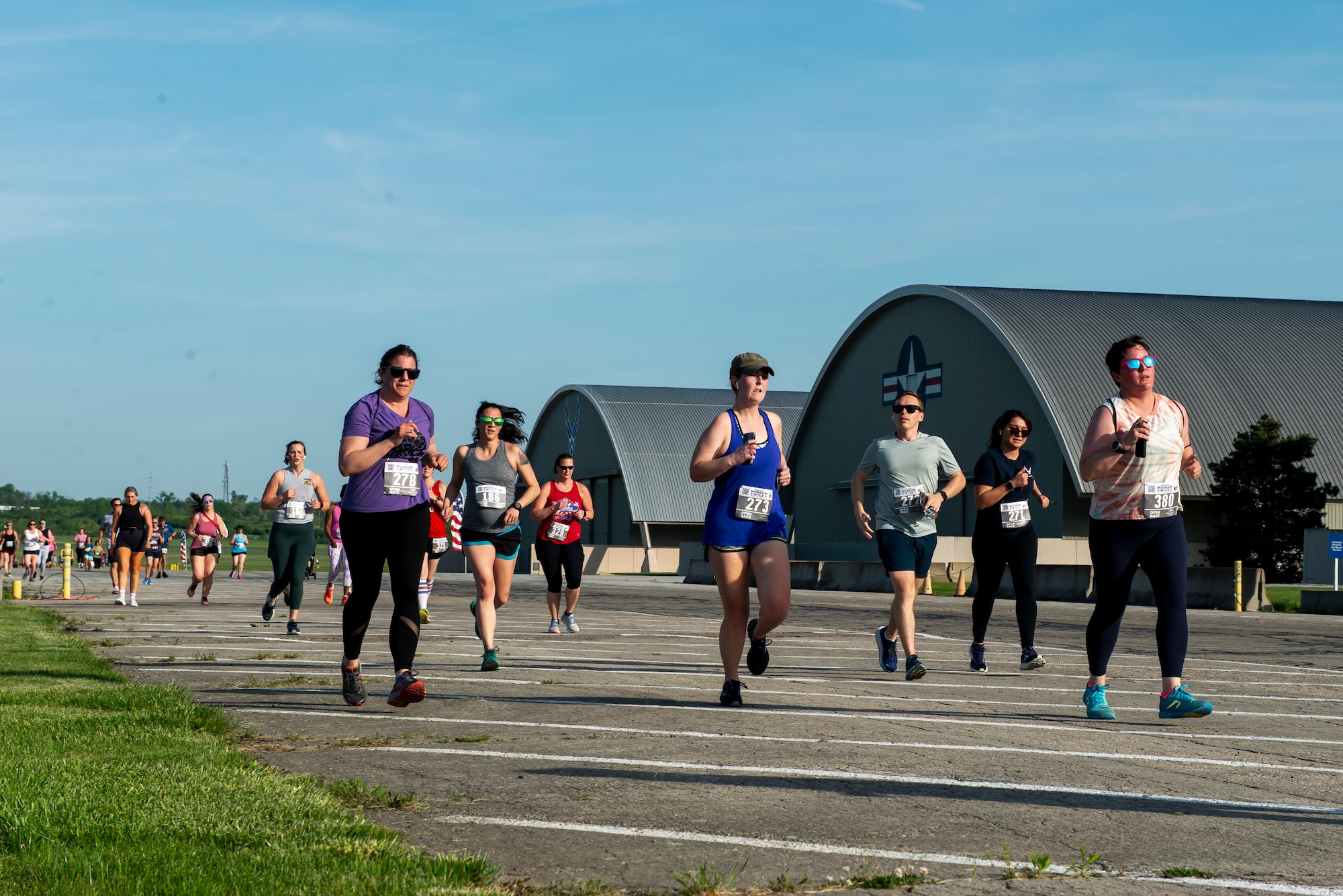 Museum Mile participants run past the second hangar at the National Museum of the United States Air Force, May 11, 2023. Nearly 400 participants ran the 1-mile family friendly course that wound through the museum grounds before finishing under the wingtips of historic aircrafts at the Air Park. (U.S. Air Force photo by A1C James Johnson.)
