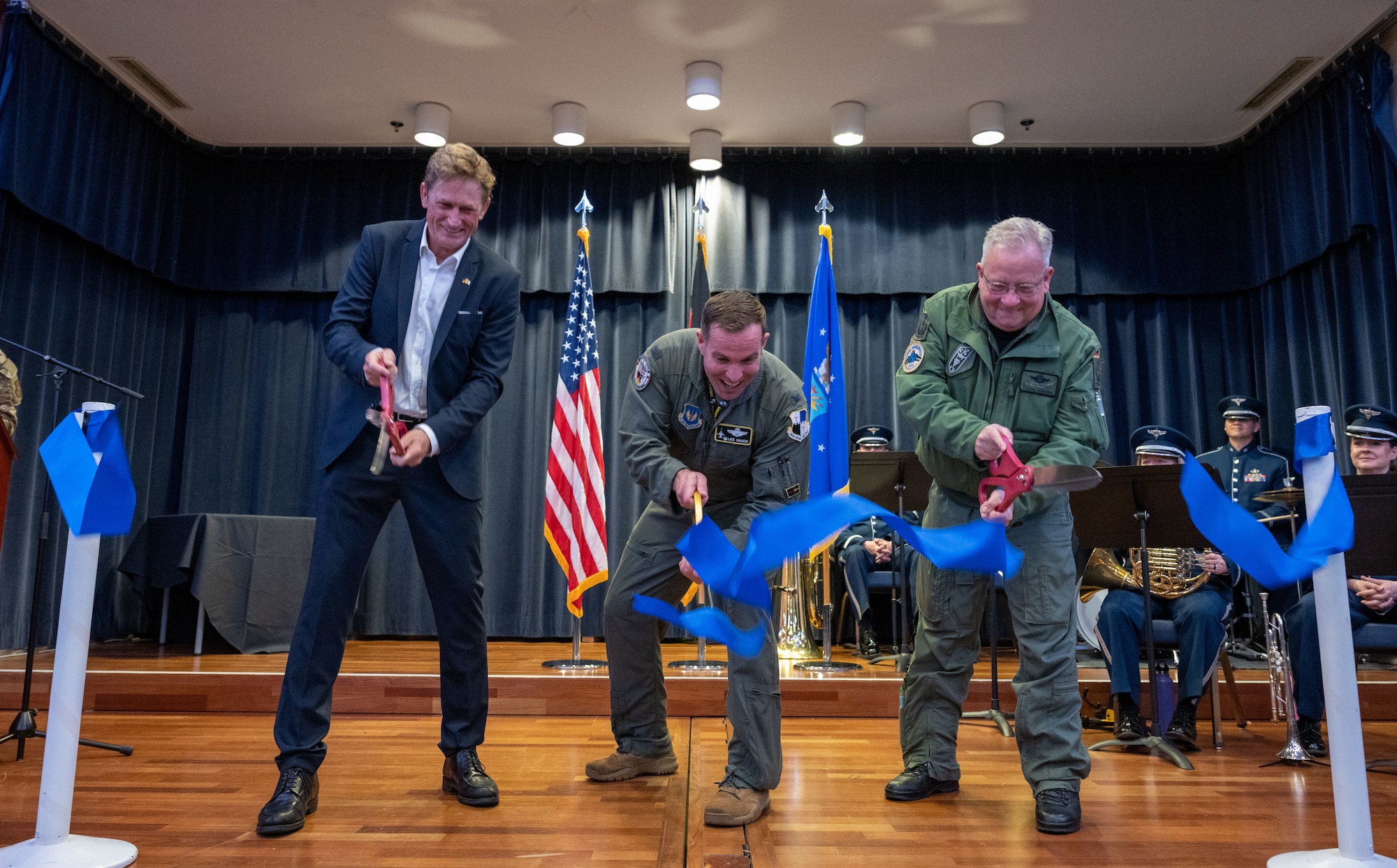 (From left) Jan Niewodniczanki, Host Nation Council president, U.S. Air Force Col. Leslie Hauck, 52nd Fighter Wing commander, and  German Air Force Colonel Thomas Schneider, Tactical Air Wing 33 commander Buchel, Germany, cut a ribbon to kick-off the Explore the Eifel event May 12, 2023, at Spangdahlem Air Base, Germany. For 70 years the U.S. Air Force has had a permanent presence at Spangdahlem AB, ensuring air superiority, protecting U.S. assets, and bolstering the economy of local communities in the Eifel region of Germany. (U.S. Air Force photo by Senior Airman Jessica Sanchez-Chen)