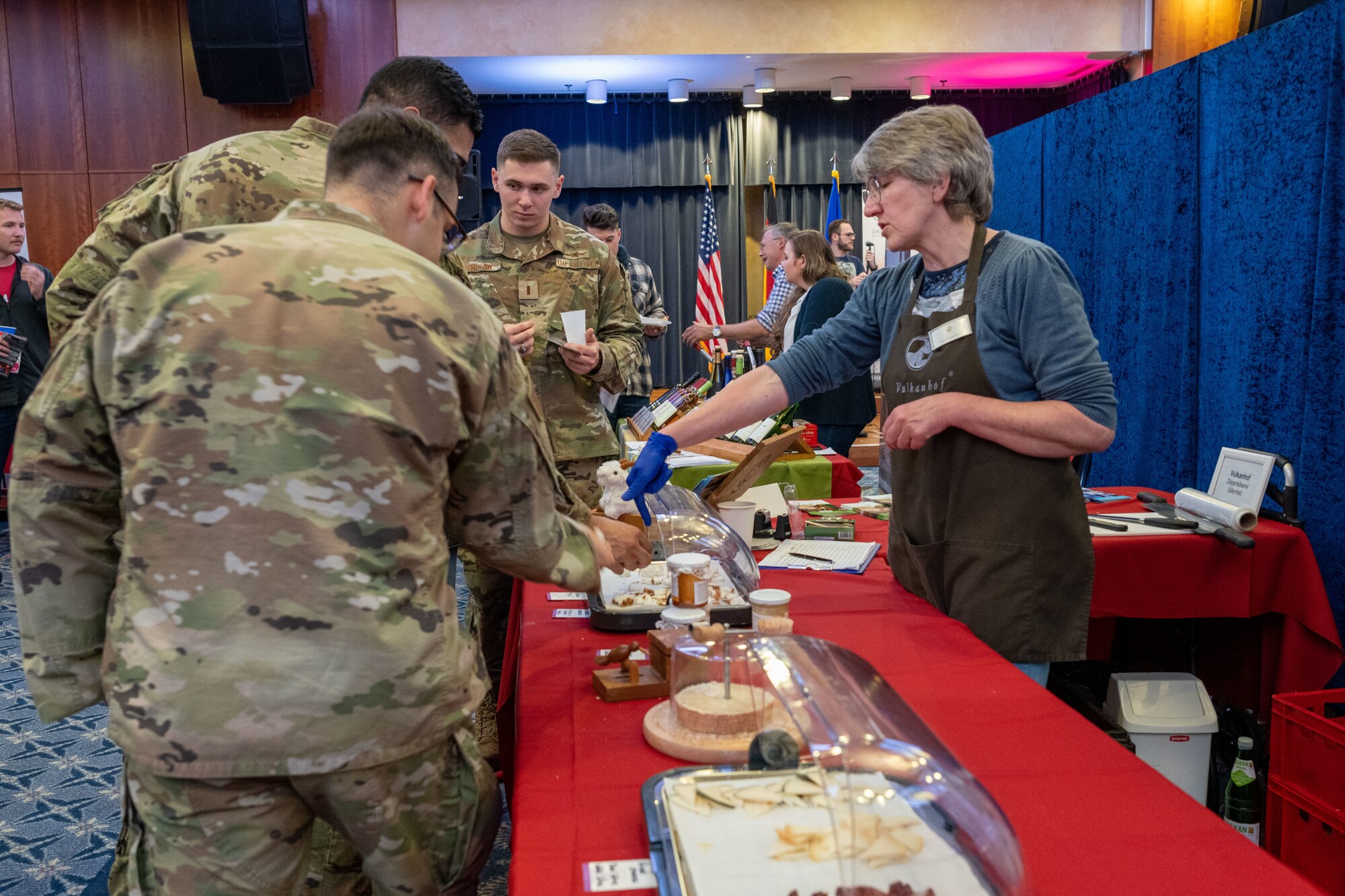 U.S. Airmen visit a German local vendor booth during Explore the Eifel May 12, 2023, at Spangdahlem Air Base, Germany. Explore the Eifel is a yearly event to introduce the Spangdahlem community to the local area. (U.S. Air Force photo by Senior Airman Jessica Sanchez-Chen)