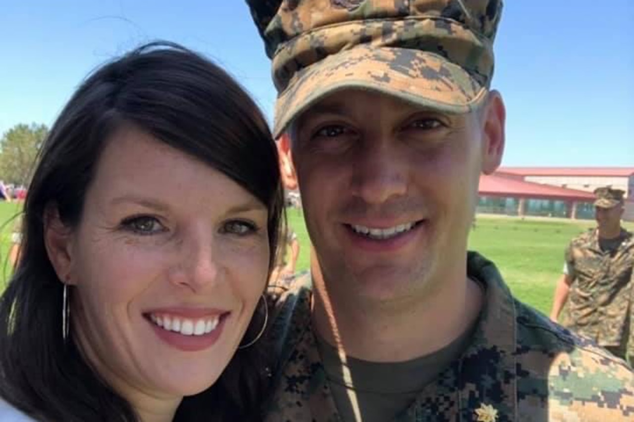 Close-up of a uniformed Marine smiling with his wife.