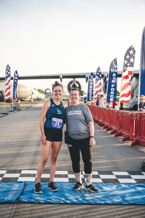 Katie Ruhlman (left), first place winner of the Women’s Elite race, and Rachael Ferguson (right), Air Force Marathon Office director, pose for a photo at the finish line at the inaugural Museum Mile event hosted by the Air Force Marathon Office May 11 at the National Museum of the U.S. Air Force, Dayton, Ohio.