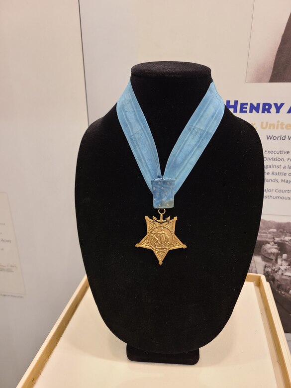 A Medal of Honor rests on a black bust.