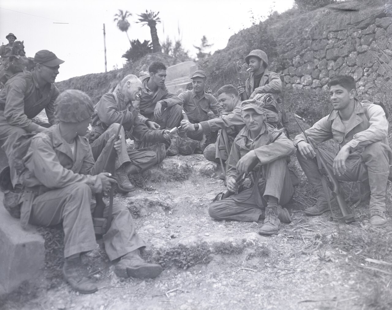 Several men sit on crude steps.