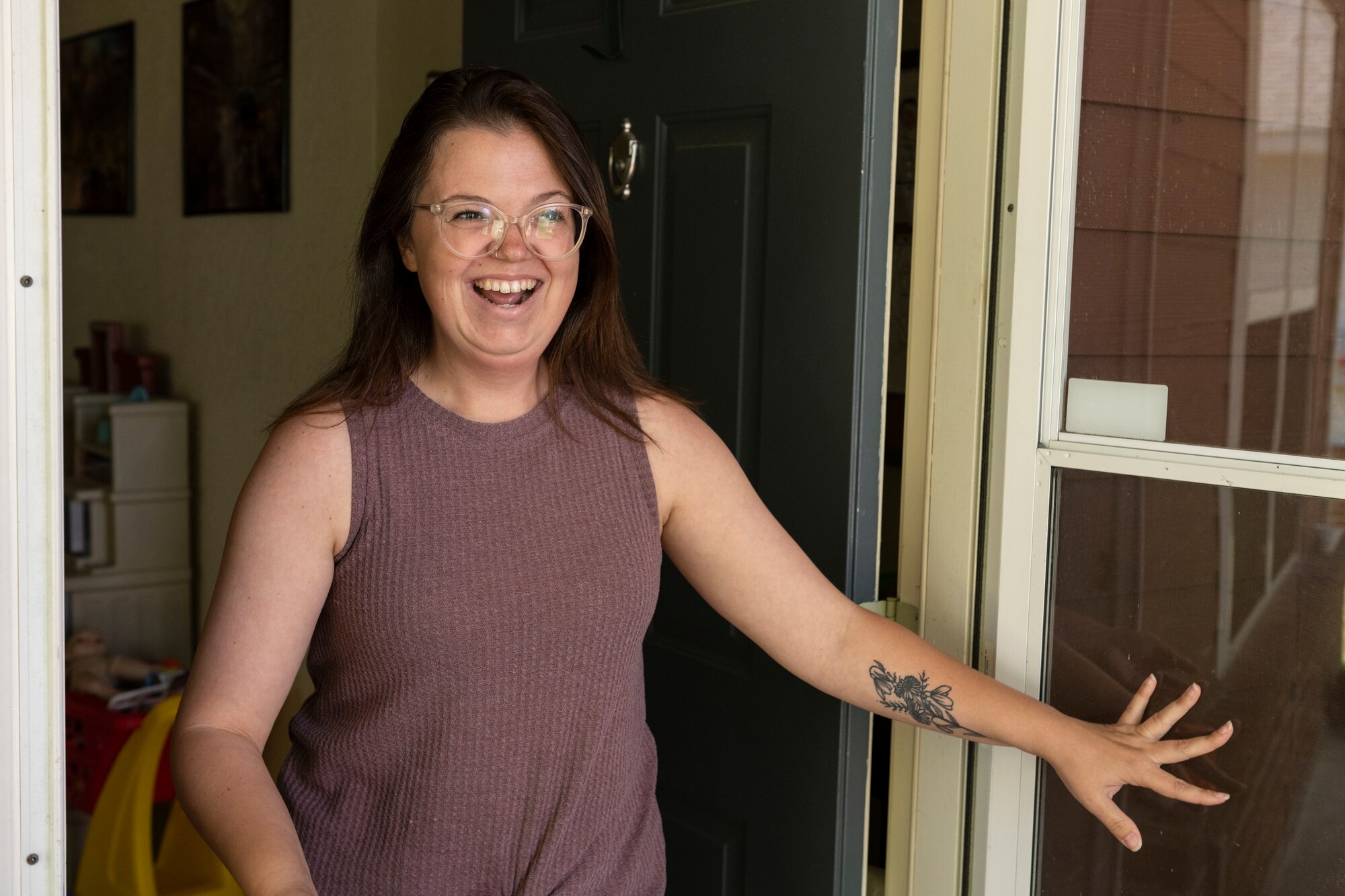 Taylor Cookson-Olson, 23rd Force Support Squadron family child care provider, opens the door of her home at Moody Air Force Base, Georgia, May 3, 2023. Cookson-Olson has been an FCC provider at Moody AFB for 11 months and has served over 30 families. (U.S. Air Force photo by Senior Airman Deanna Muir)