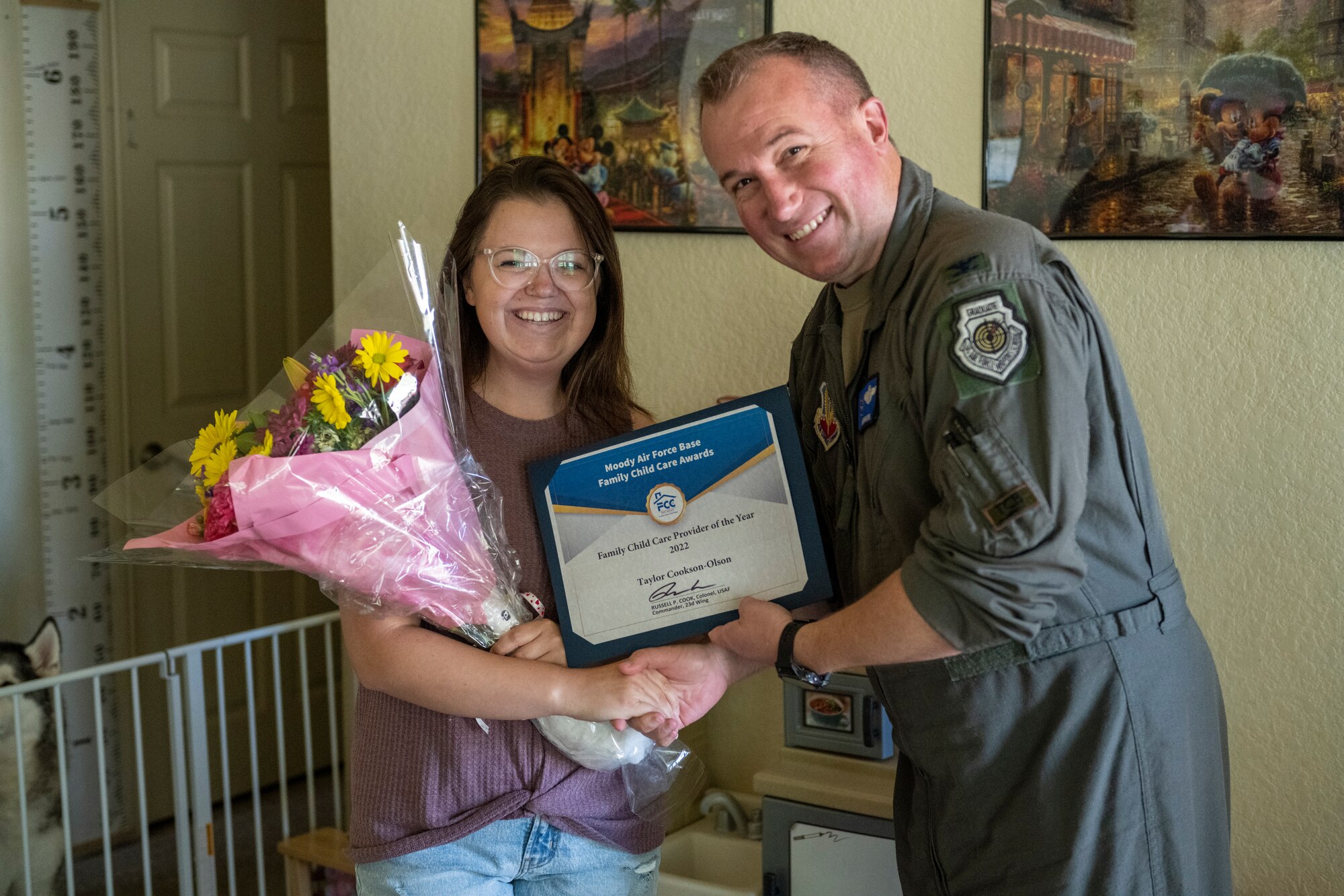 U.S. Air Force Col. Ryan Hayde, 23rd Wing vice commander, presents Taylor Cookson-Olson, 23rd Force Support Squadron family child care provider, with the Family Child Care provider of the year 2022 award at Moody Air Force Base, Georgia, May 3, 2023. Cookson-Olson was lauded for her contributions to Team Moody’s FCC program and the support she gives to families. (U.S. Air Force photo by Senior Airman Deanna Muir)