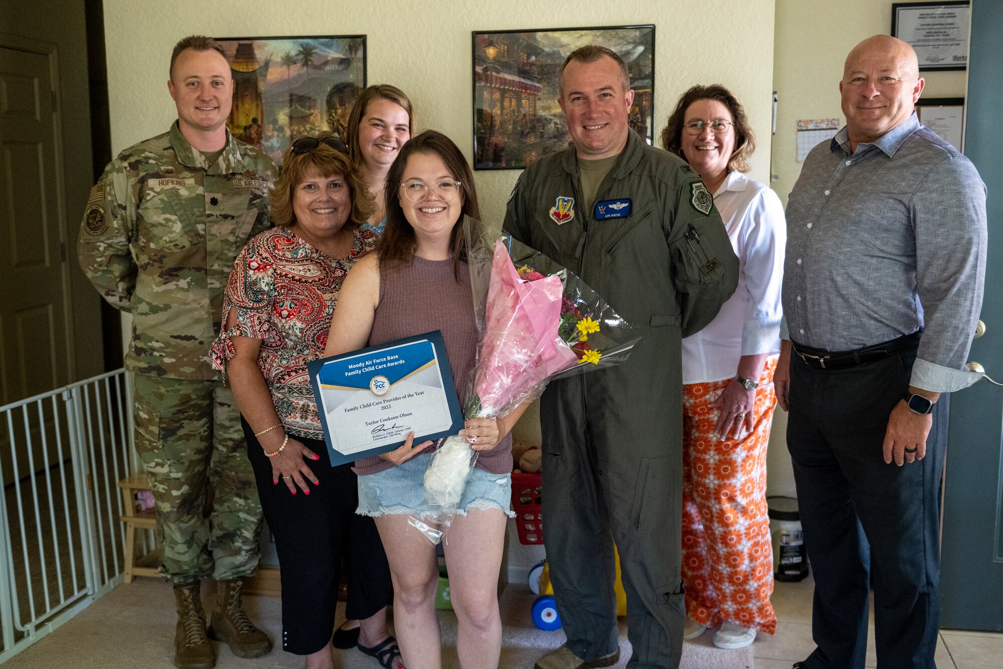 Taylor Cookson-Olson, 23rd Force Support Squadron family child care provider of the year 2022, and Team Moody personnel pose for a photo at Moody Air Force Base, Georgia, May 3, 2023. The FCC providers offer care to military families, not only to meet full-time child care needs, but care for special circumstances unique to the military lifestyle. (U.S. Air Force photo by Senior Airman Deanna Muir)